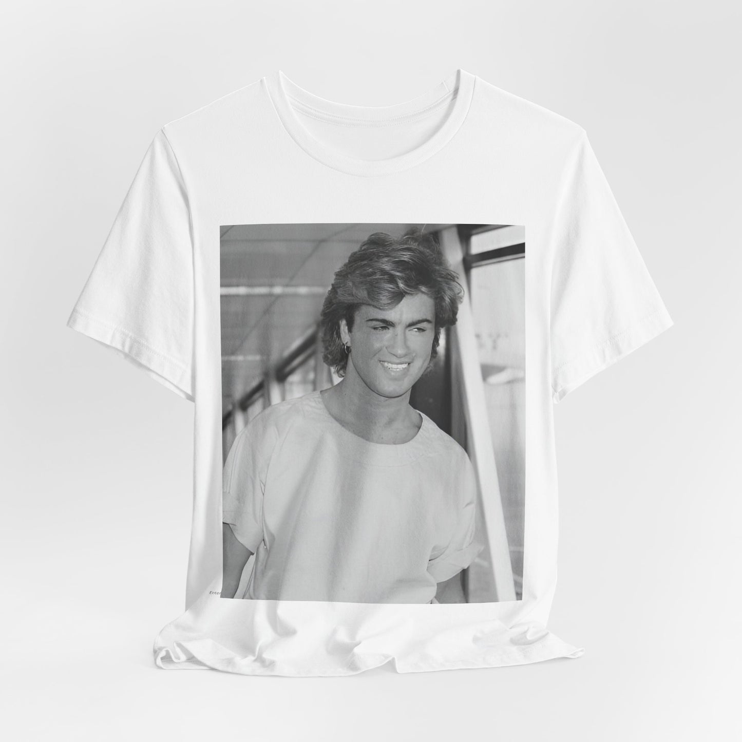 A black graphic t-shirt featuring an 80s black and white vintage photo or graphic of George Michael.