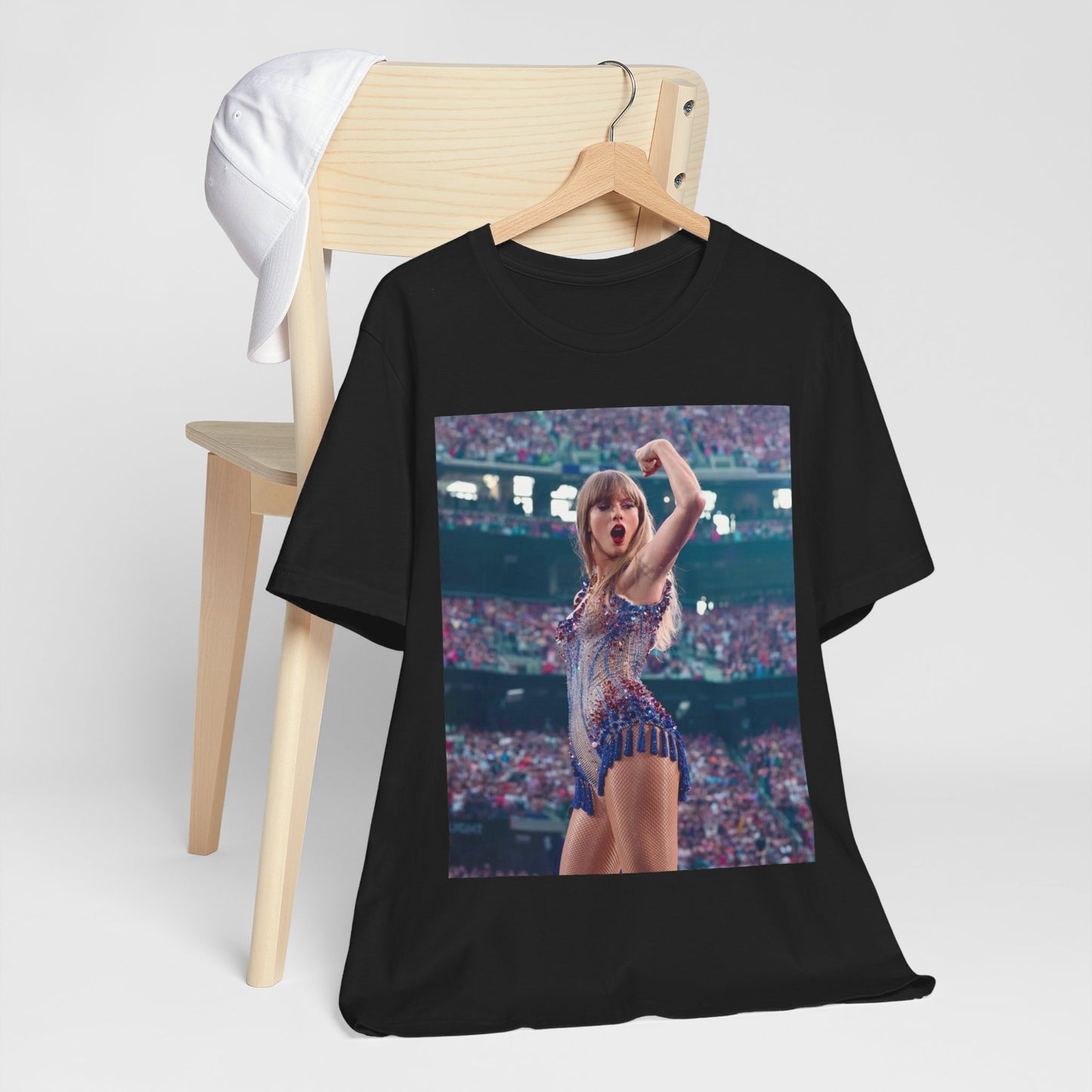 A black graphic t-shirt featuring a graphic or photo of Taylor Swift performing live on stage.