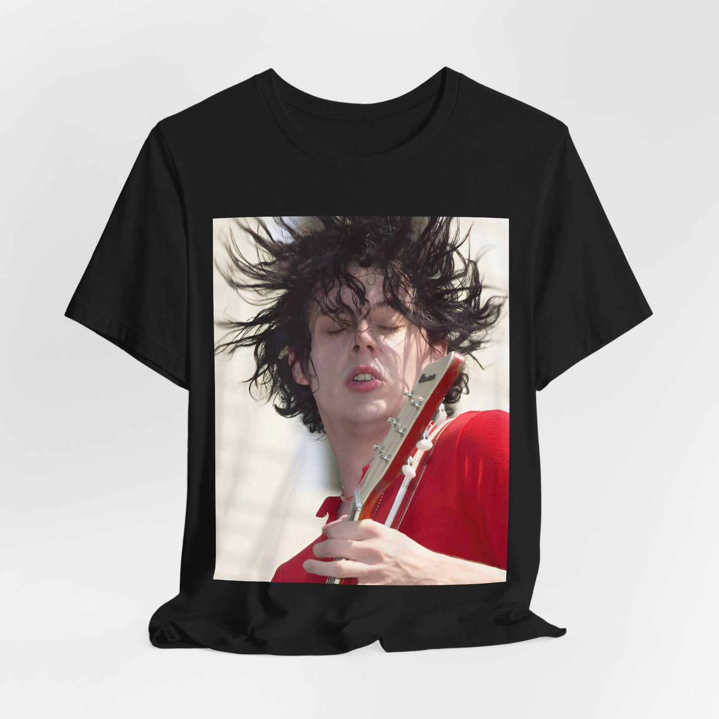 A black graphic t-shirt featuring a retro graphic of Jack White from The White Stripes playing guitar.