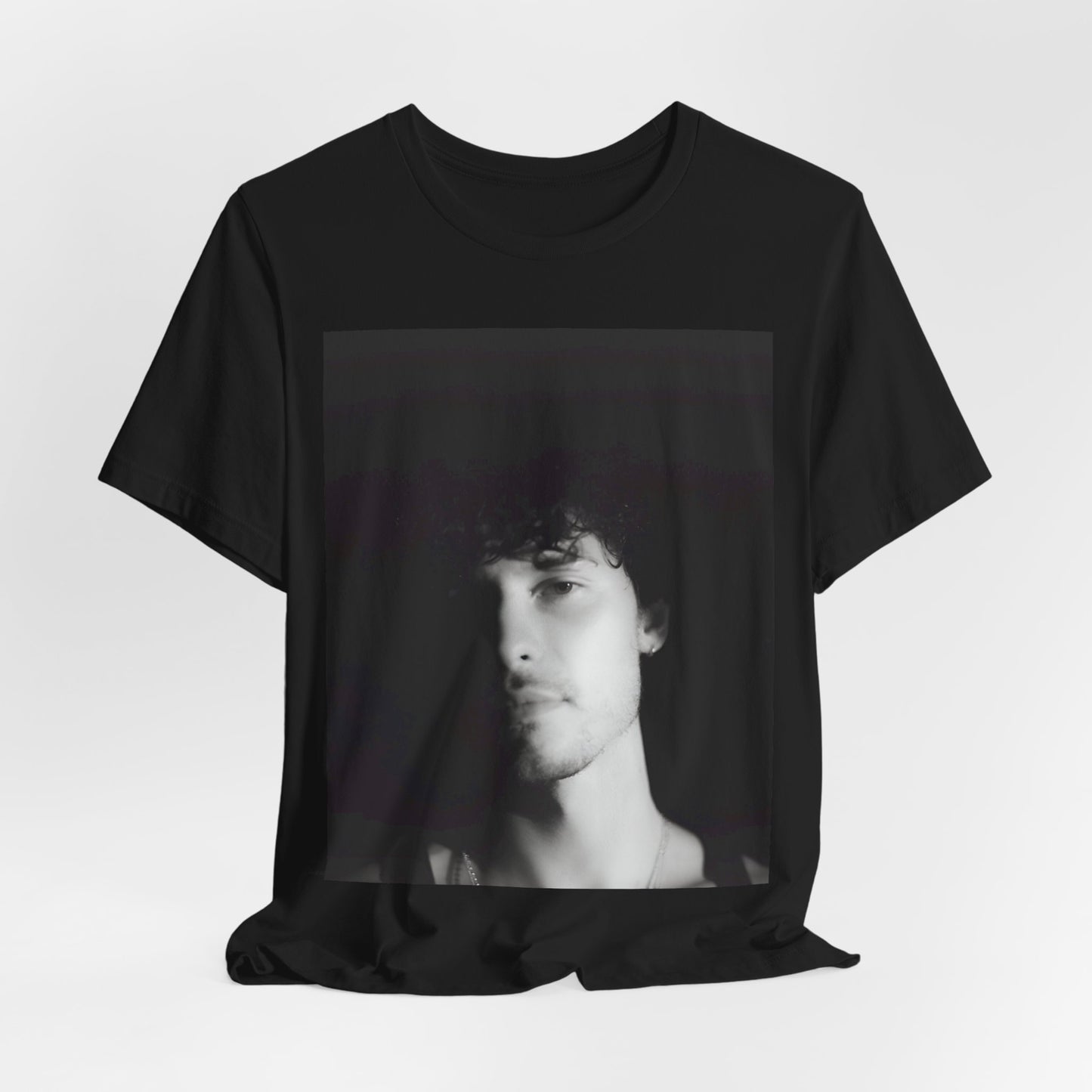 A black graphic t-shirt featuring a black and white portrait photo of Shawn Mendes.