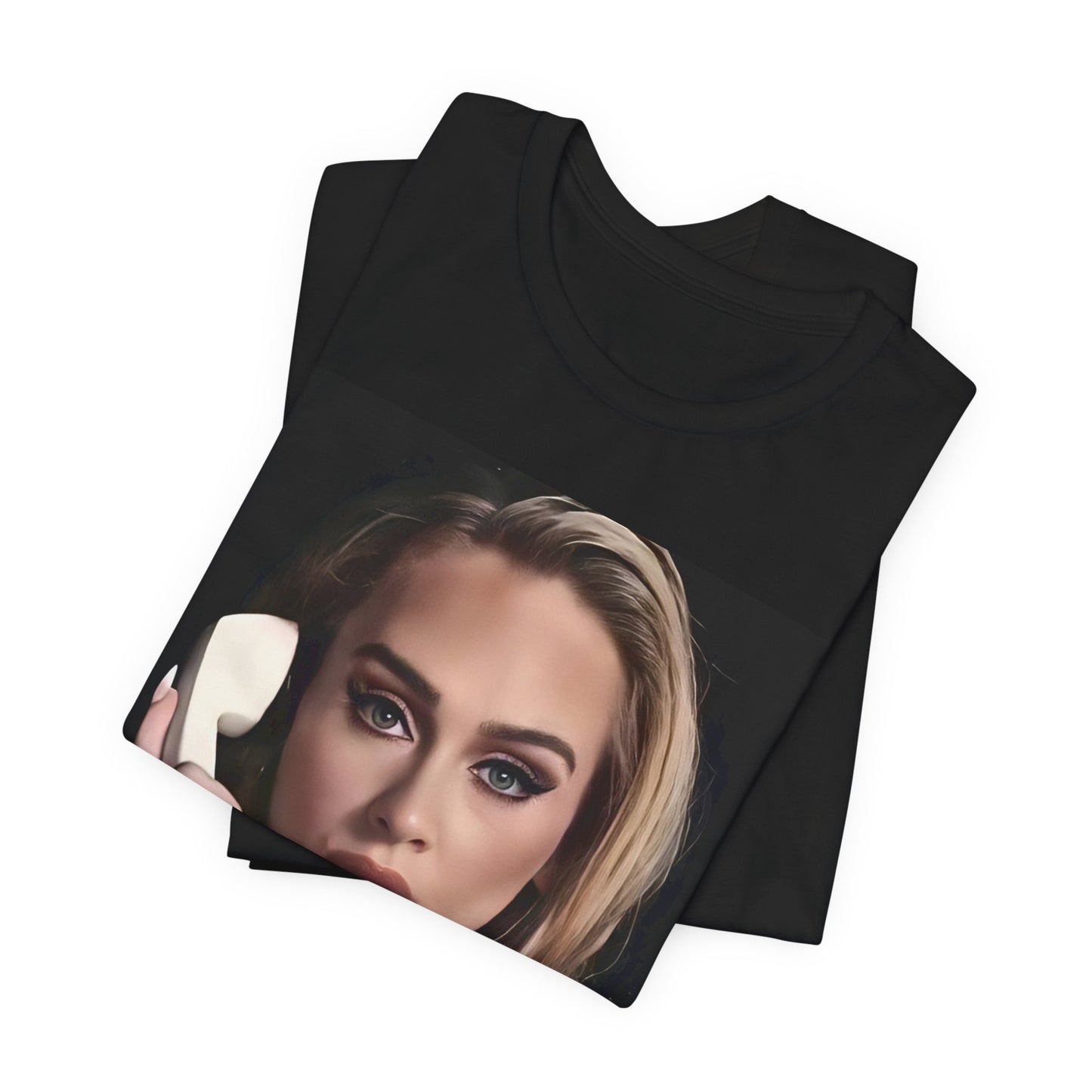 A black graphic t-shirt featuring a black and white candid photo of Adele with a phone to her ear, showing a thoughtful or emotional expression.