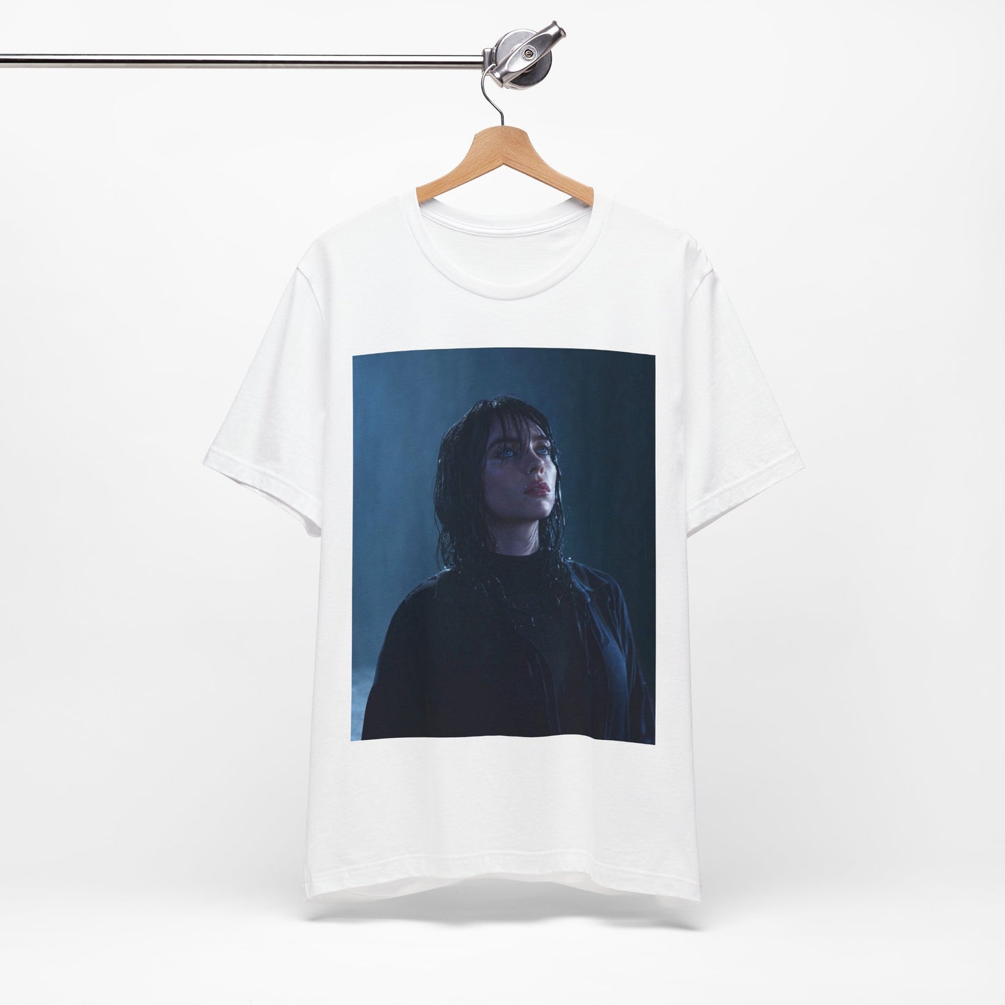 A direct, powerful portrait of Billie Eilish, embodying the 'HIT ME HARD AND SOFT' album era, printed on a graphic t-shirt.