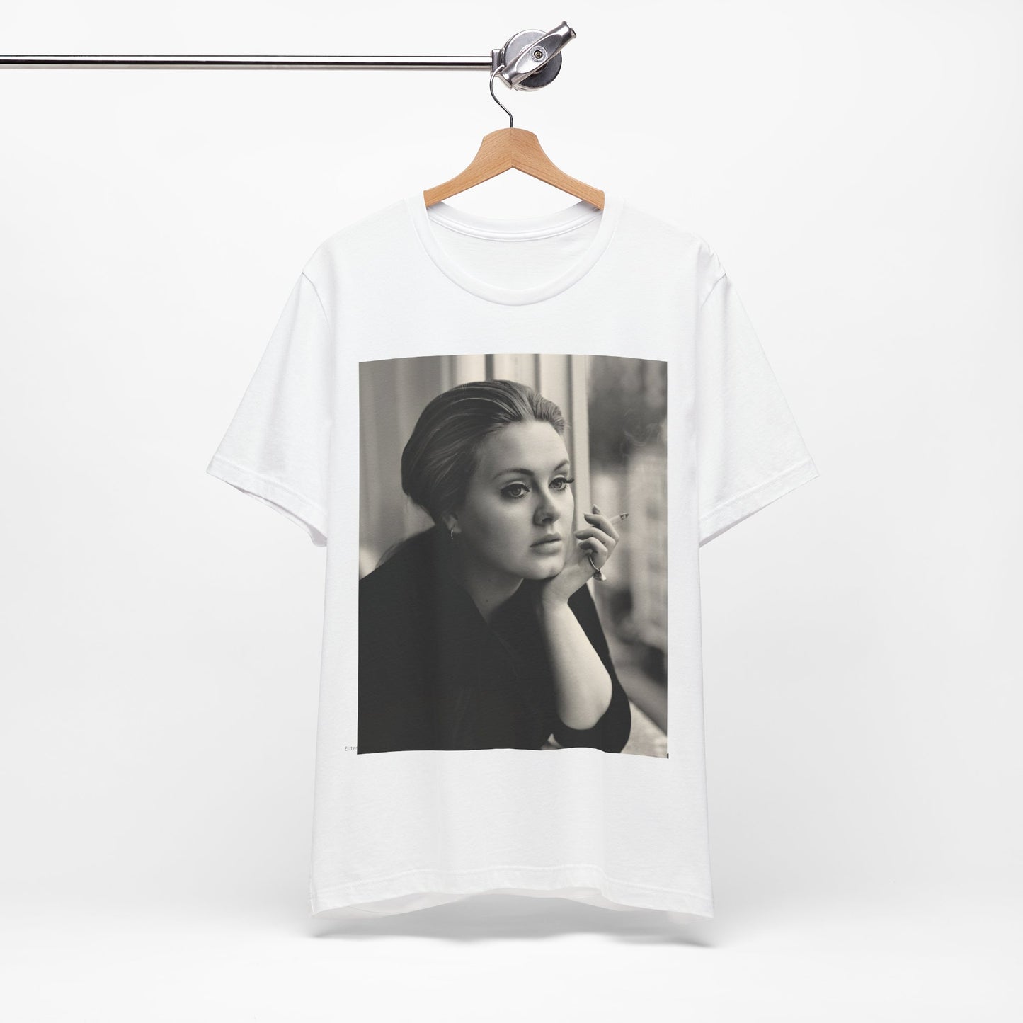 A black graphic t-shirt featuring a black and white photo of Adele, showing her with a serene or thoughtful expression.