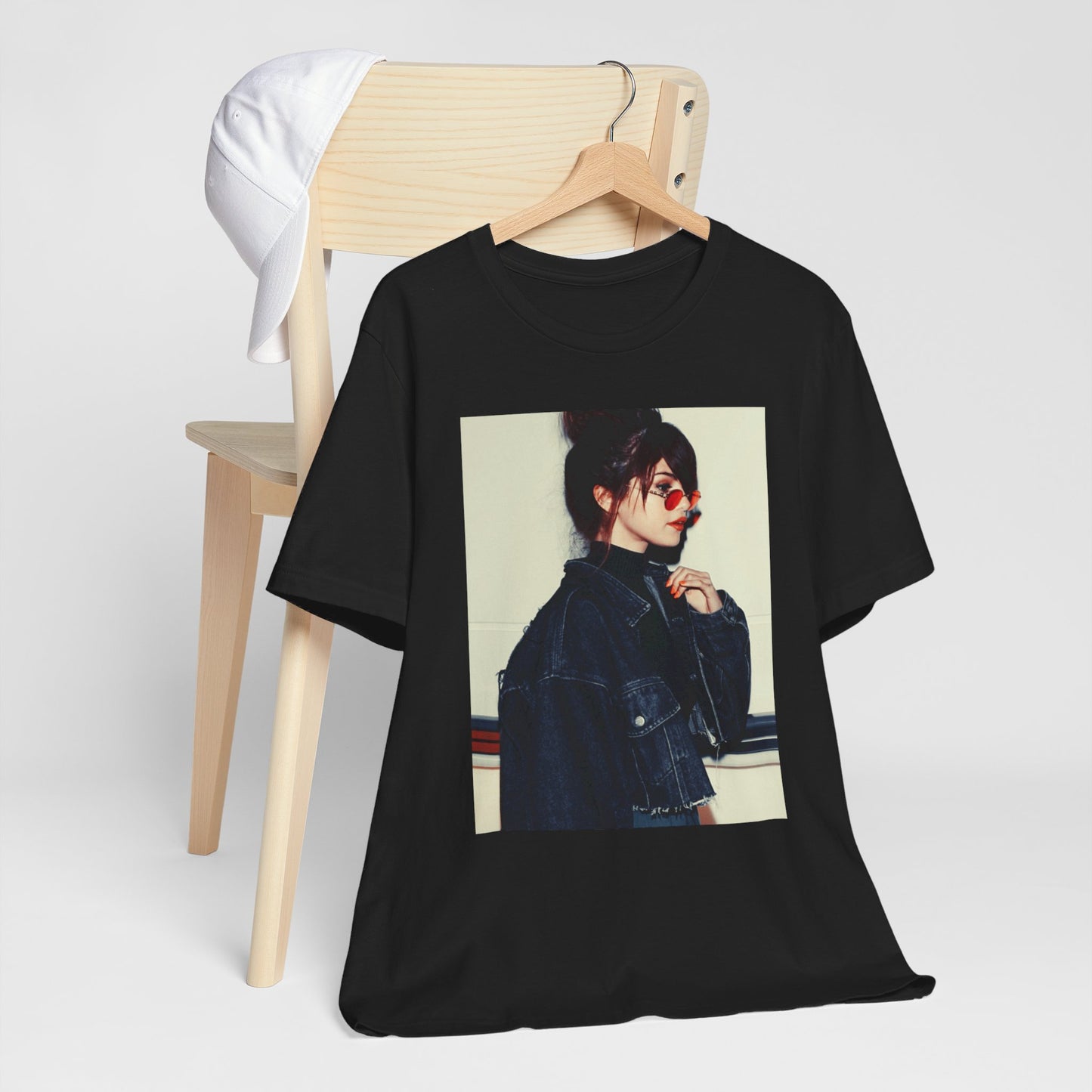 A black graphic t-shirt featuring a bold graphic of Selena Gomez as a pop superstar.