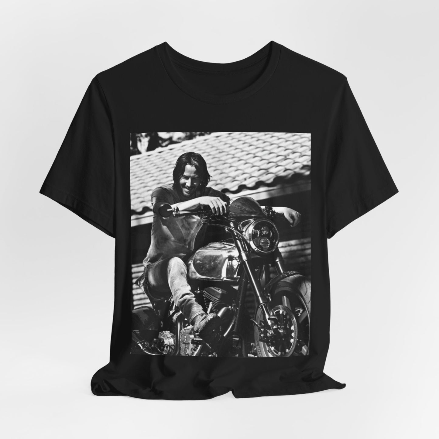 A black graphic t-shirt featuring a black and white photo of Keanu Reeves on a motorcycle.