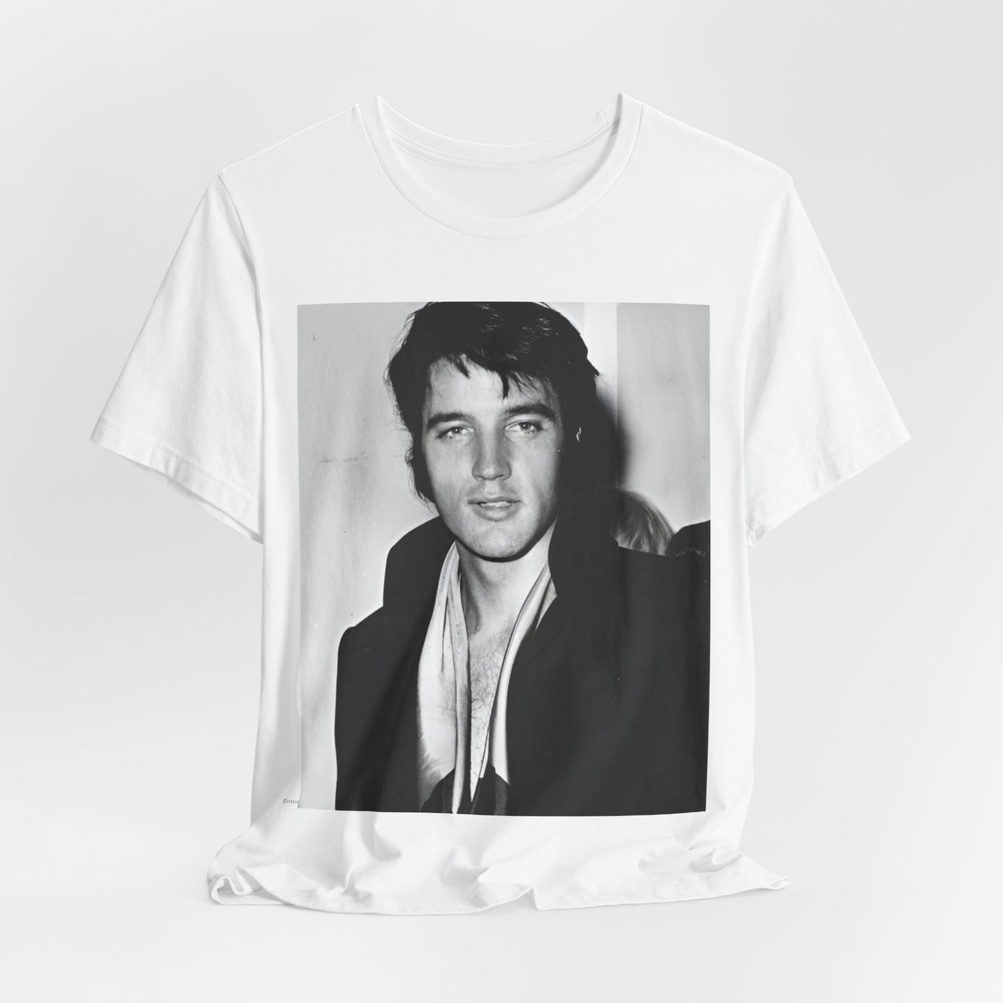 A black graphic t-shirt featuring a black and white rock and roll portrait photo of Elvis Presley.