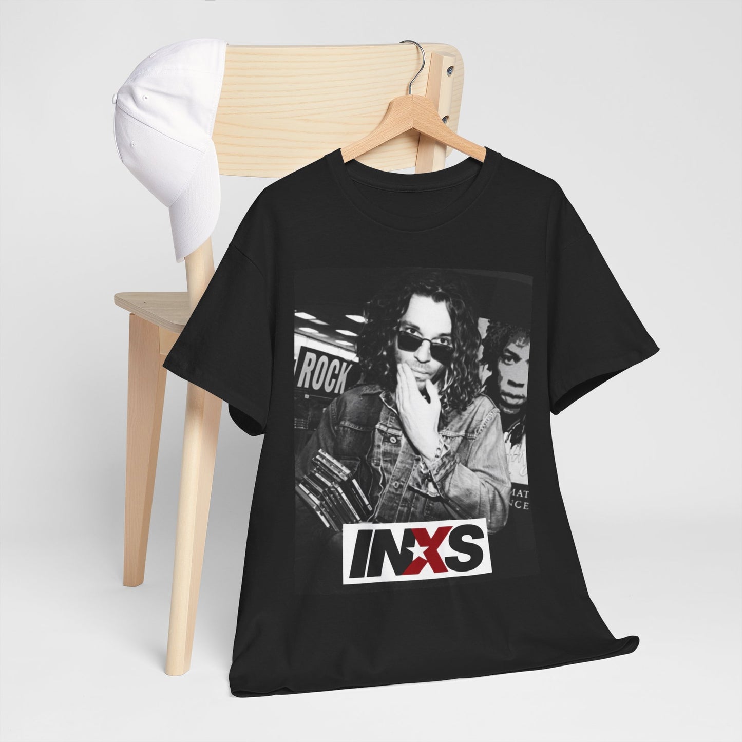 A black graphic t-shirt featuring a black and white, monochrome graphic or photo of INXS.