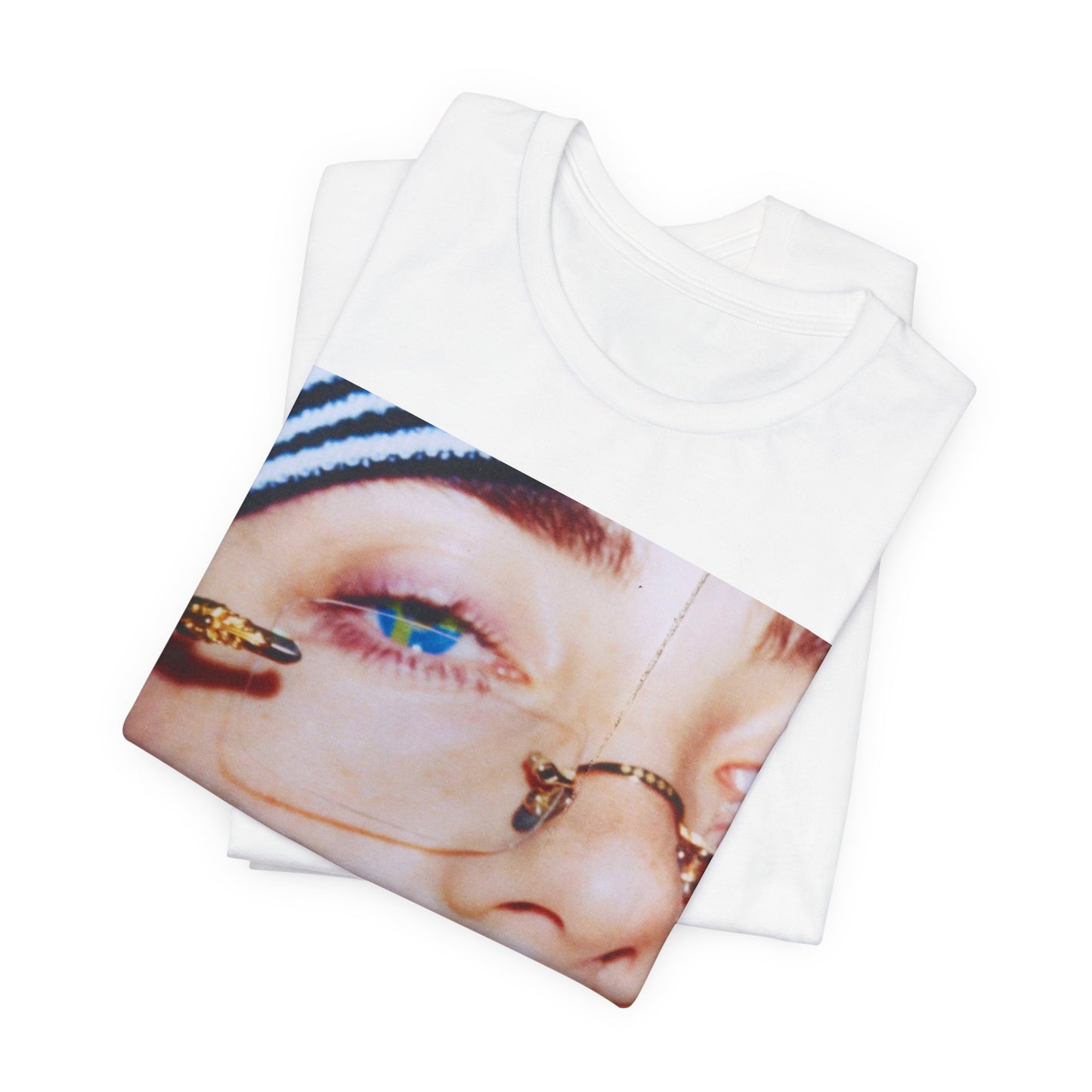 A direct, unfiltered, close-up portrait of Billie Eilish with dark hair looking straight at the camera, printed on a t-shirt.