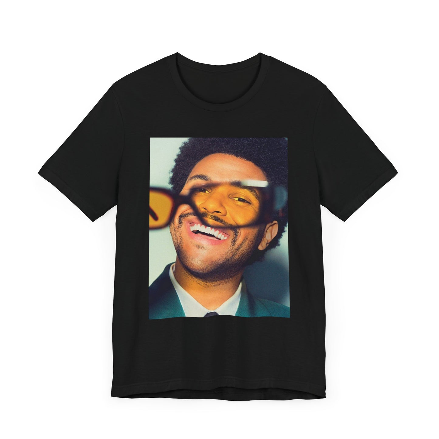 A black graphic t-shirt featuring a bold graphic of The Weeknd as a pop superstar.