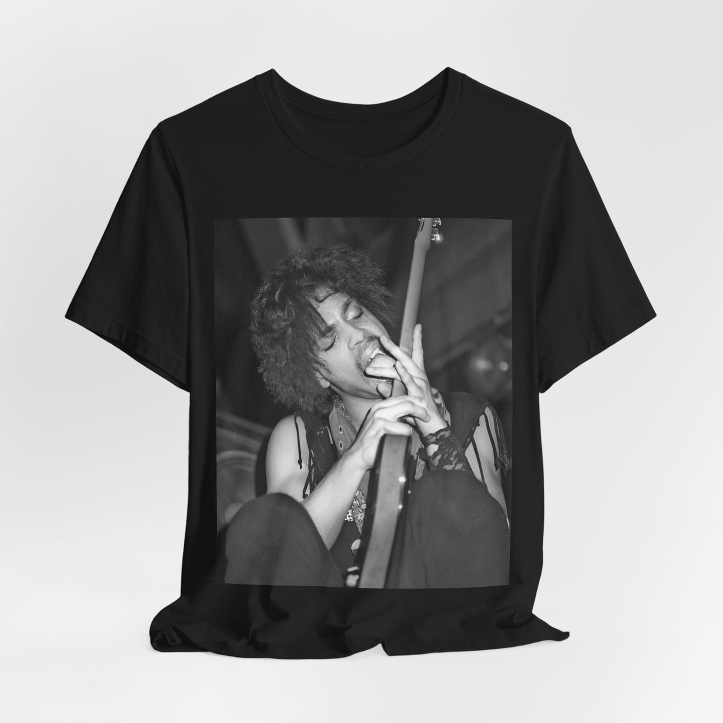 A black graphic t-shirt featuring a graphic or photo of Prince performing wildly on stage.