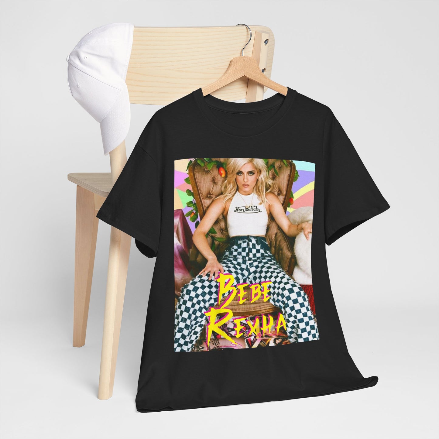 A black graphic t-shirt featuring a bold and dynamic graphic of Bebe Rexha, designed with a pop aesthetic.