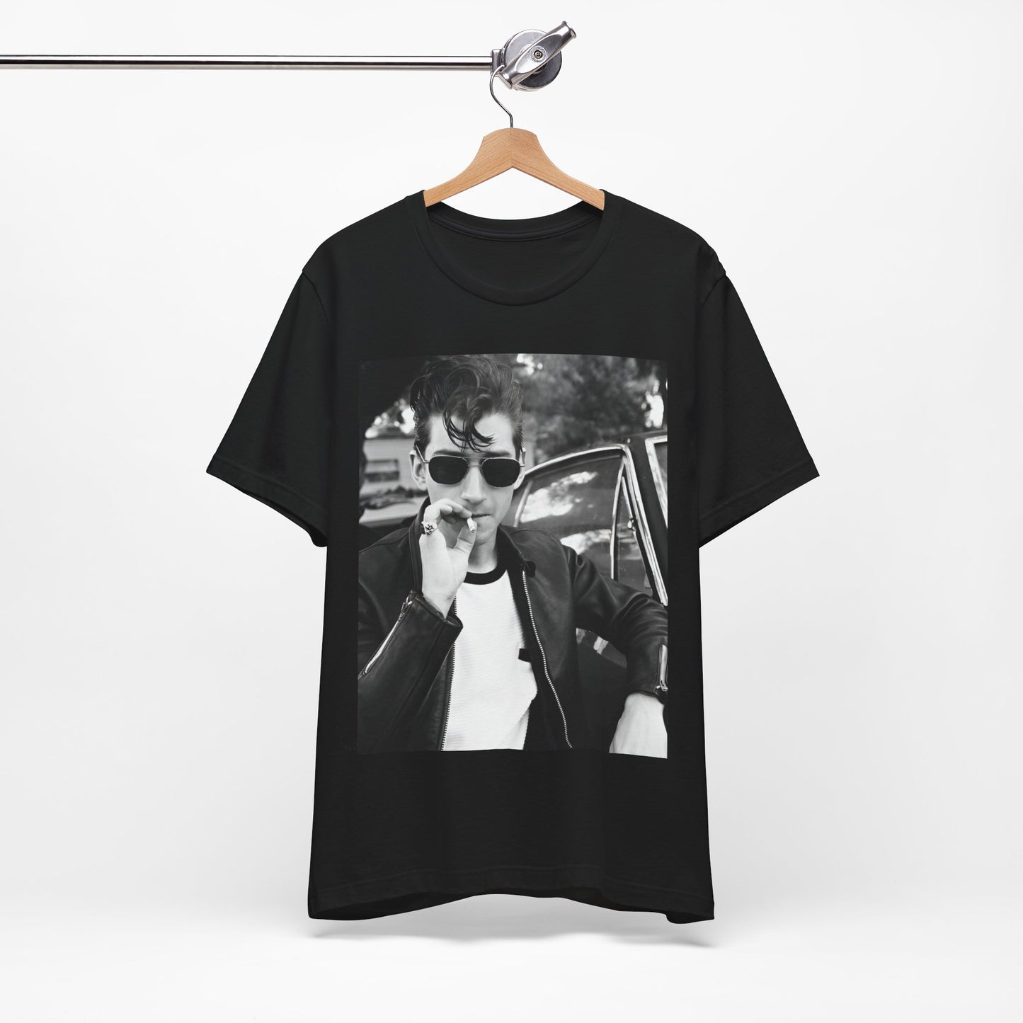A black graphic t-shirt featuring a classic rock-style graphic of the Arctic Monkeys, possibly with band members in a stylized design.