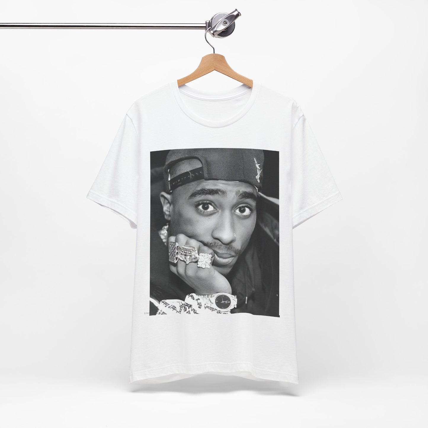A black graphic t-shirt featuring a bold graphic of Tupac as a rap superstar.