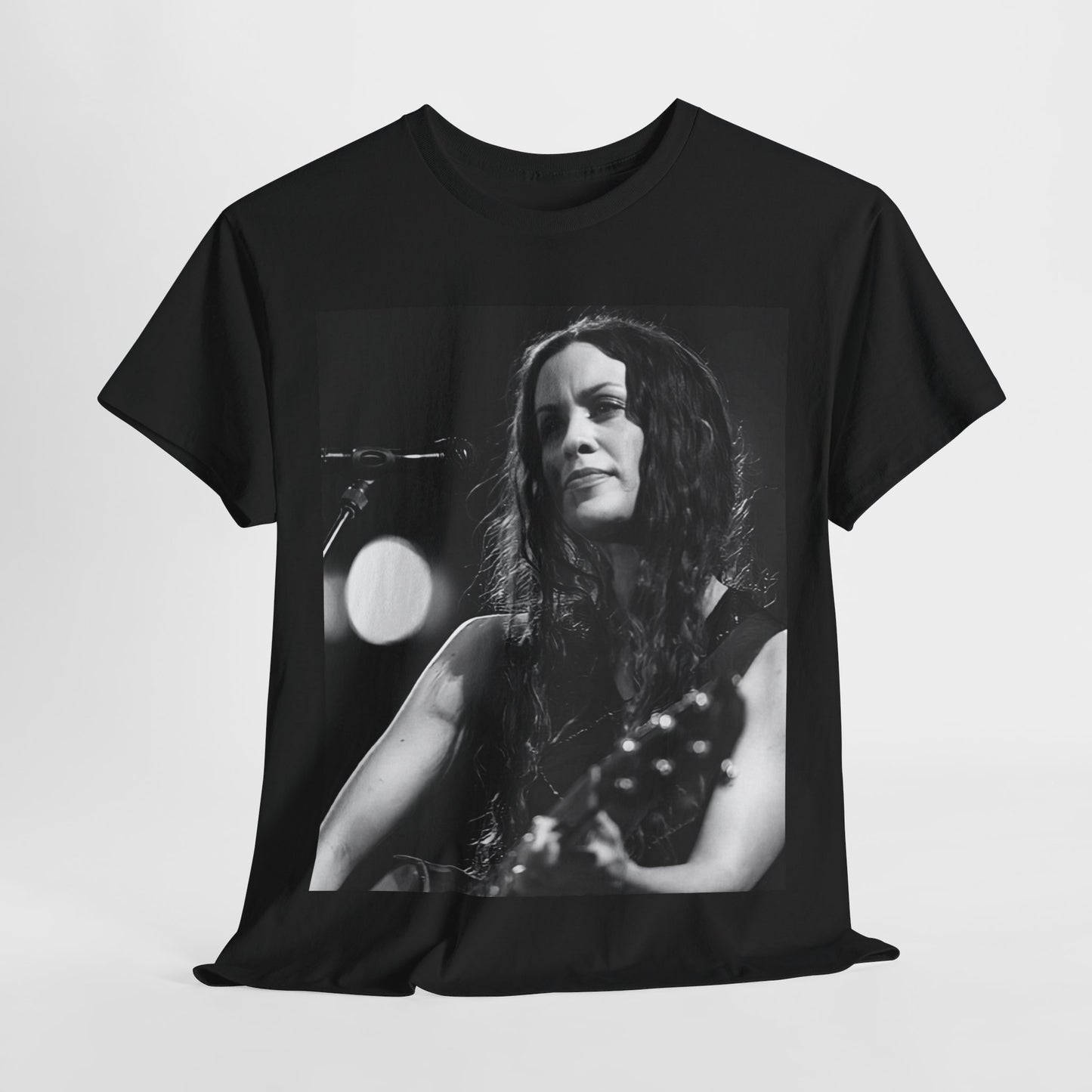 A black graphic t-shirt featuring a 90s-style graphic of Alanis Morissette playing a guitar, with a dynamic expression.