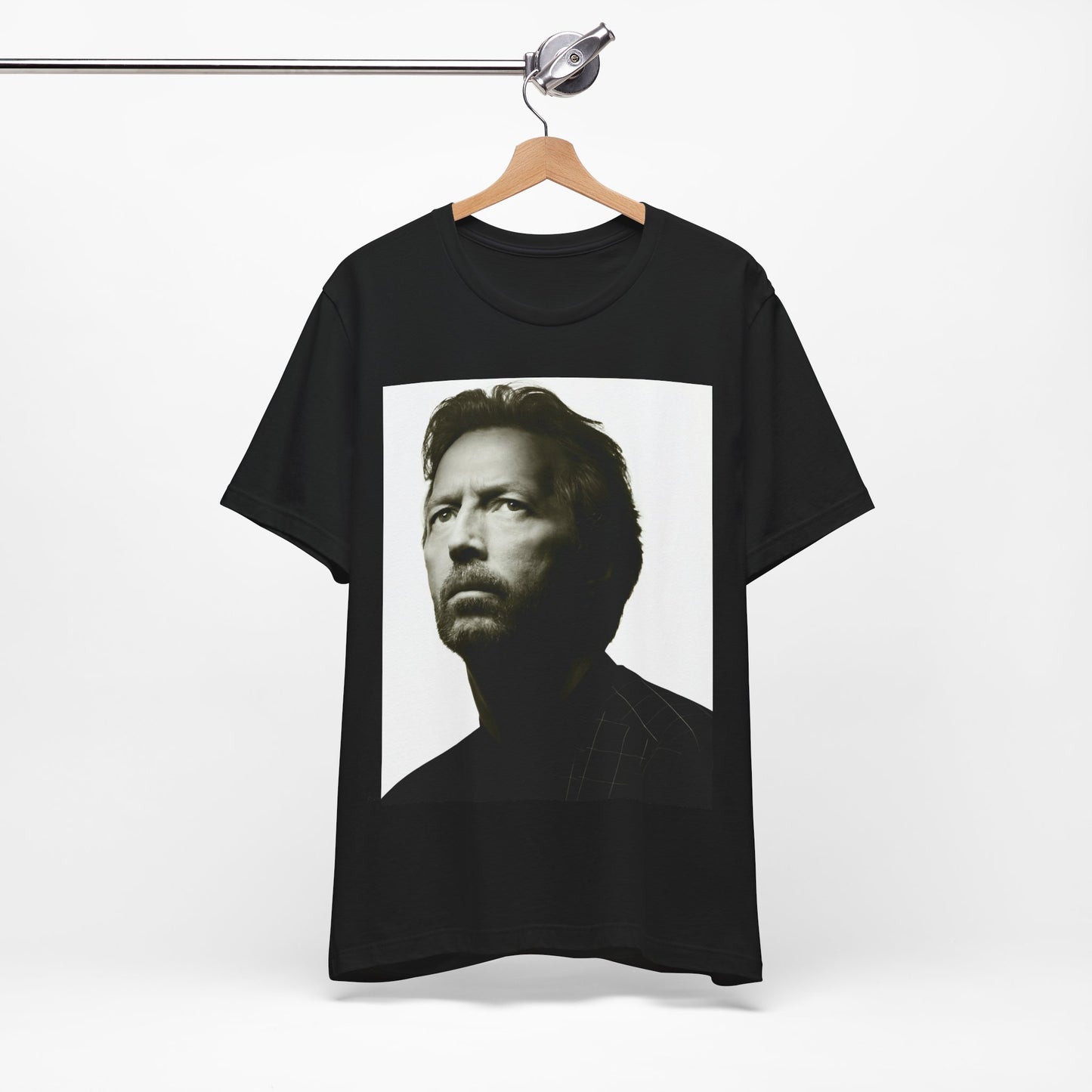 A black graphic t-shirt featuring a retro black and white portrait photo of Eric Clapton.