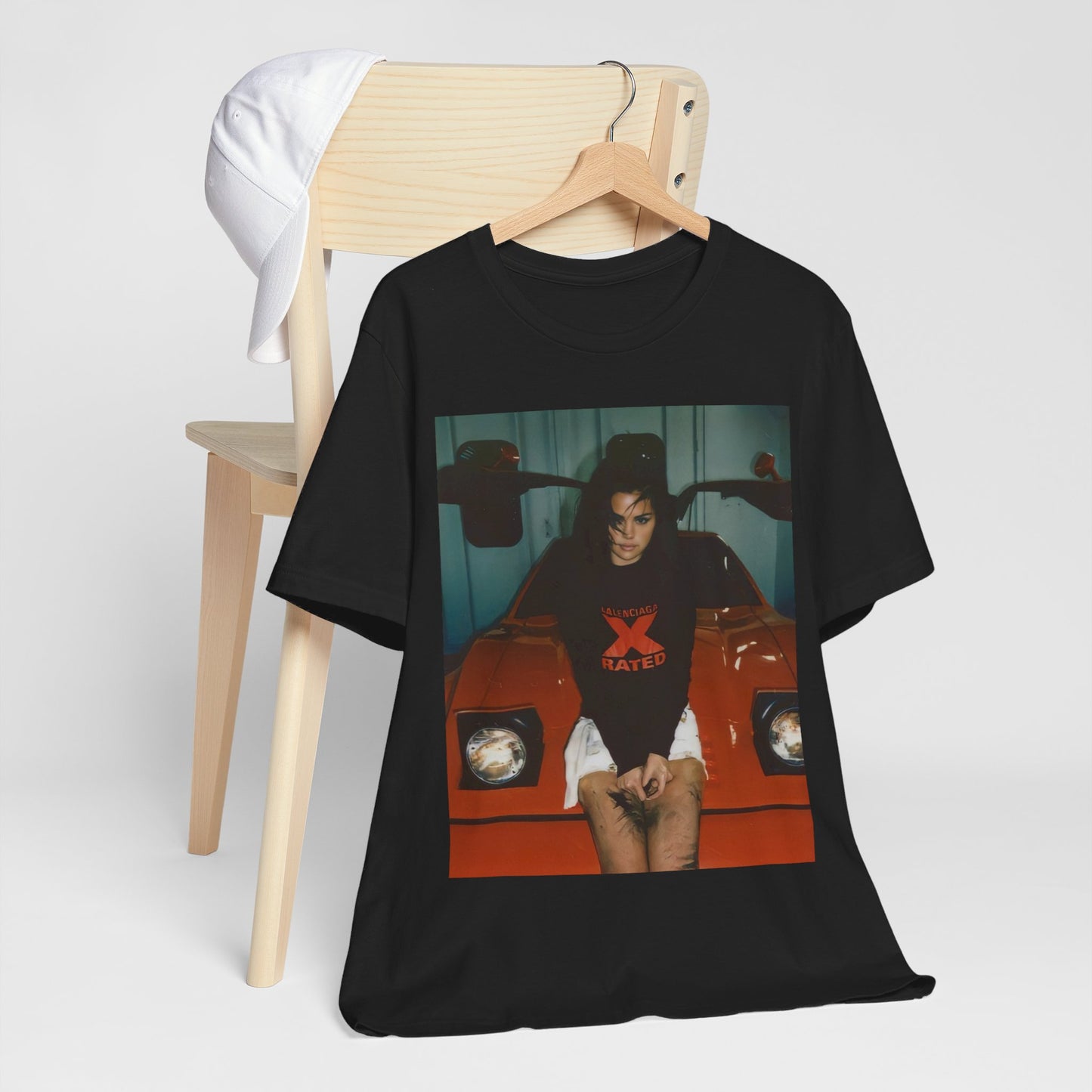 A black graphic t-shirt featuring a photo or graphic of Selena Gomez with a car, designed with an 'X Rated' or edgy aesthetic.