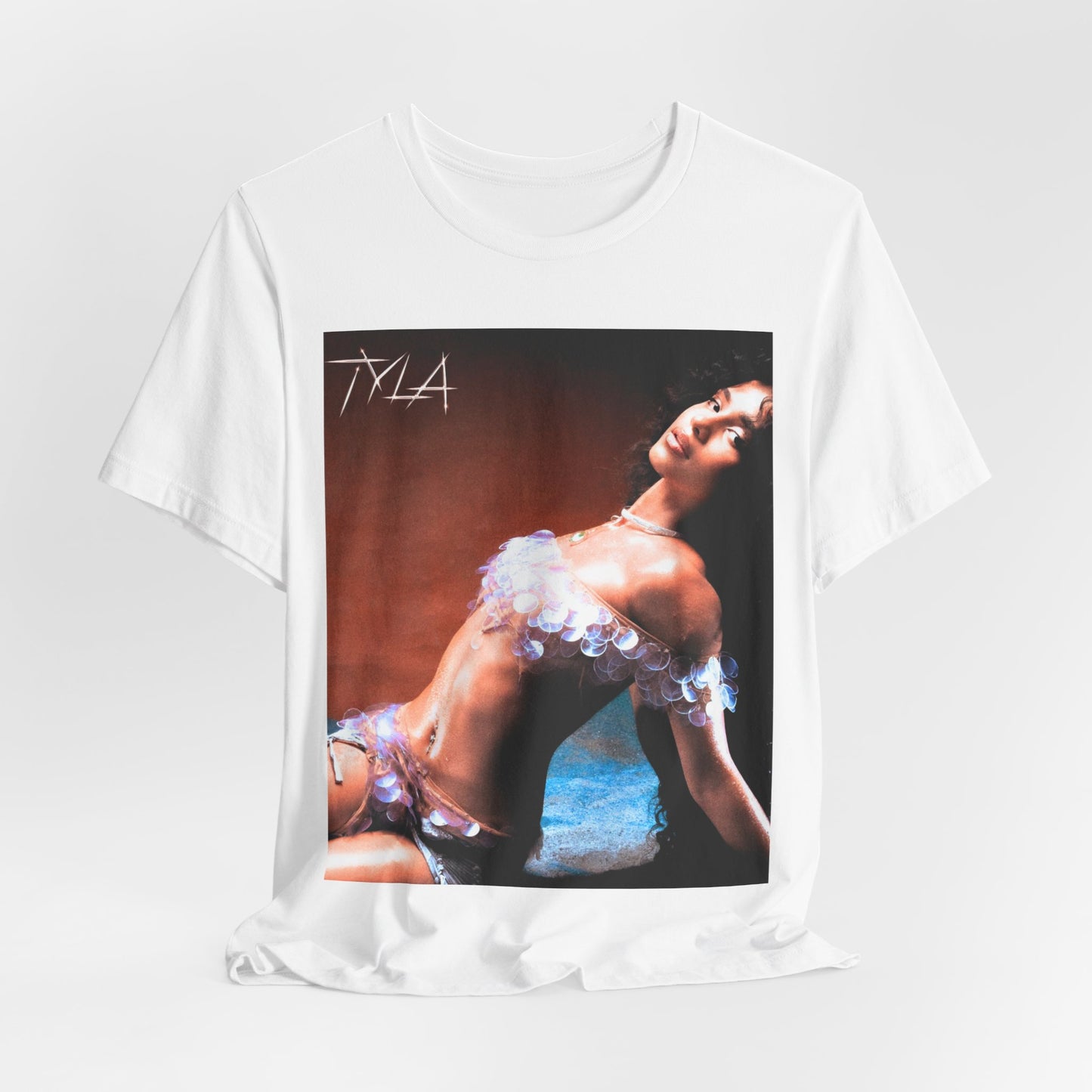 A black graphic t-shirt featuring a cultural fusion vibes graphic of Tyla.