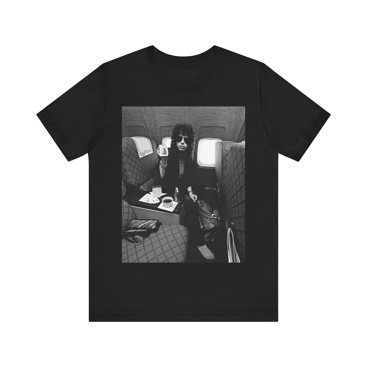A black graphic t-shirt featuring a vintage 70s-style illustration of an airplane with Aerosmith branding, representing their tour plane from that era.