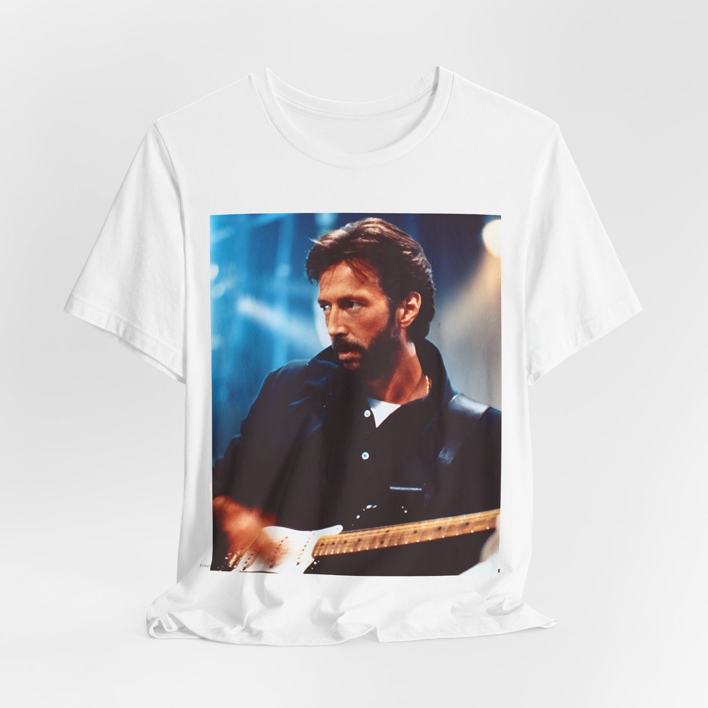 A black graphic t-shirt featuring a retro graphic or photo of Eric Clapton performing live on stage.