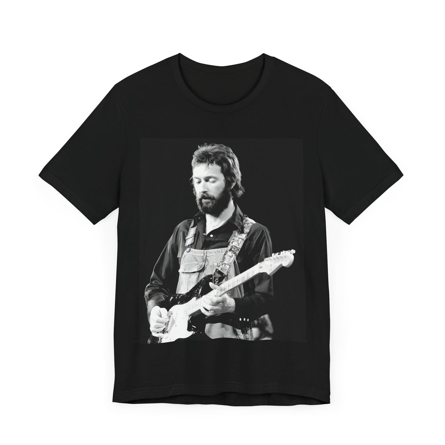 A black graphic t-shirt featuring a graphic or photo of Eric Clapton performing live on stage with his guitar.