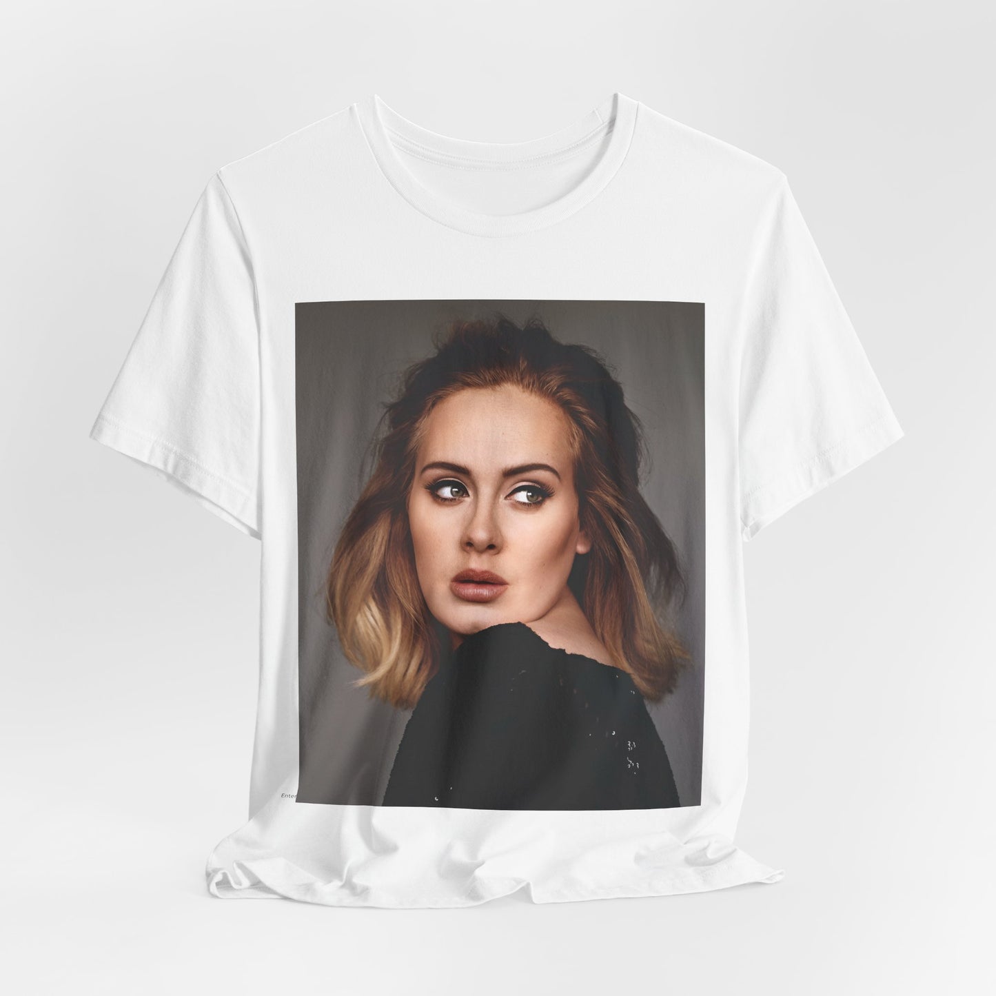 A black graphic t-shirt featuring a studio portrait of Adele from her '25' album era, showing a thoughtful or serene expression.