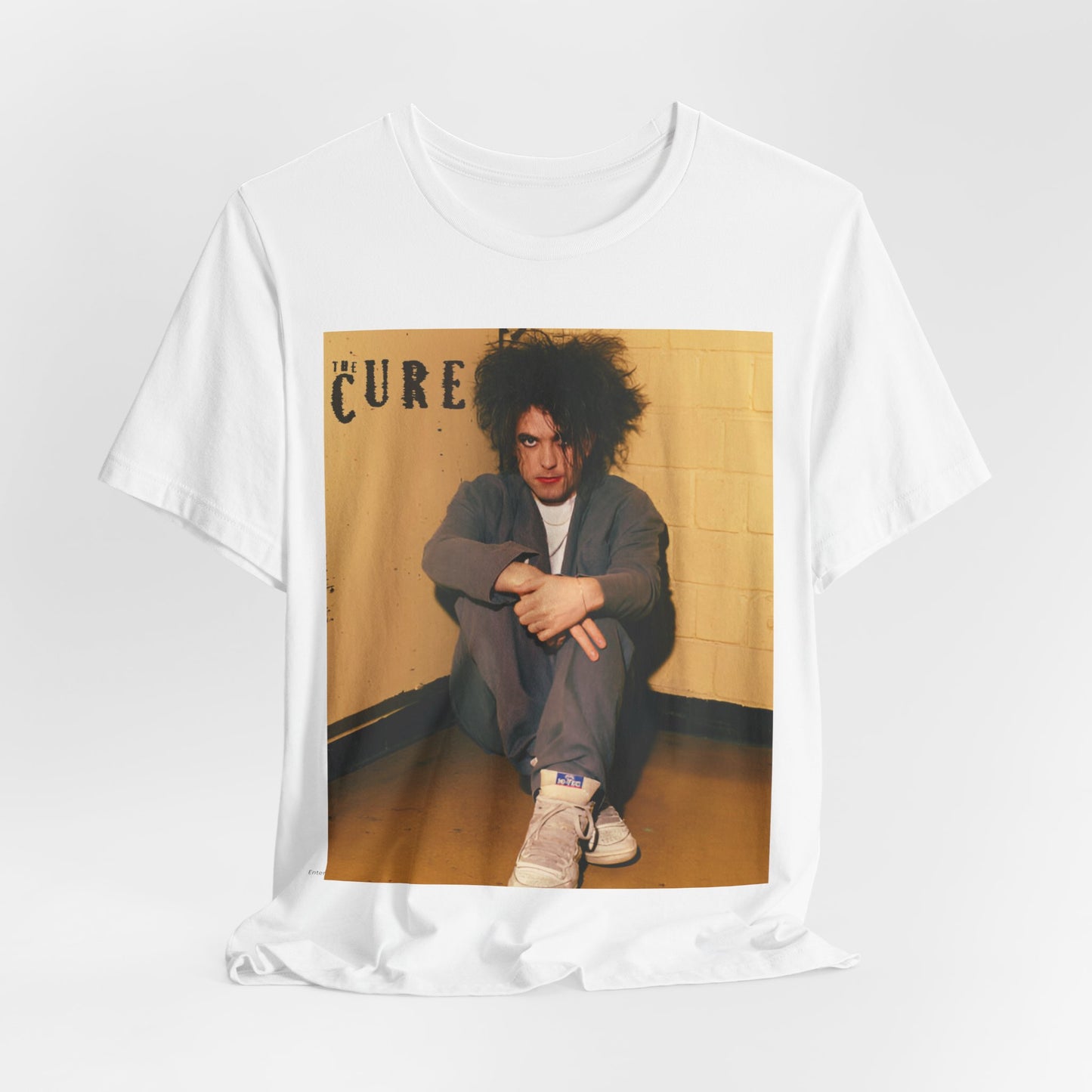 A black graphic t-shirt featuring a bold goth rock superstar graphic of The Cure.