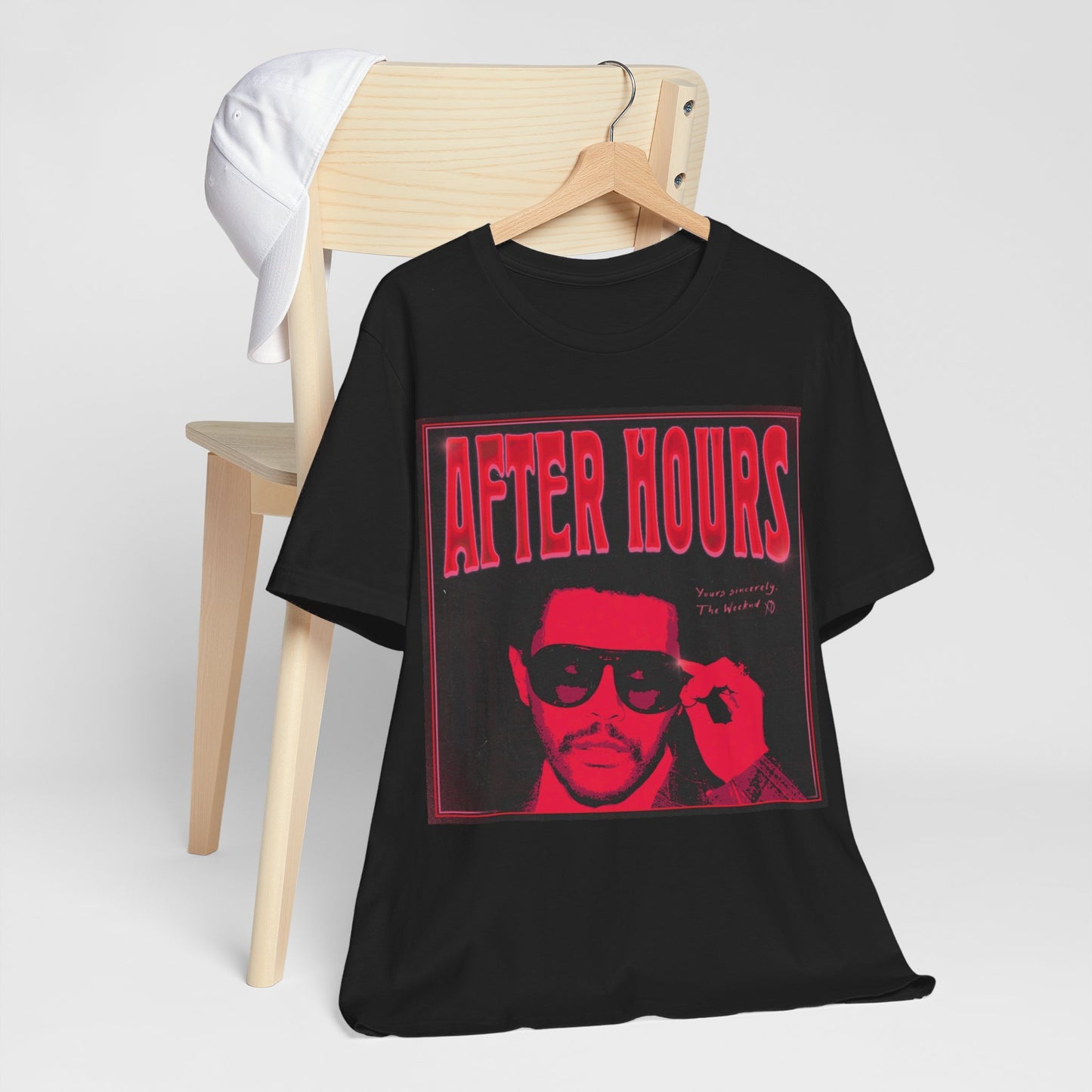A black graphic t-shirt featuring a retro graphic related to The Weeknd's 'After Hours' album.