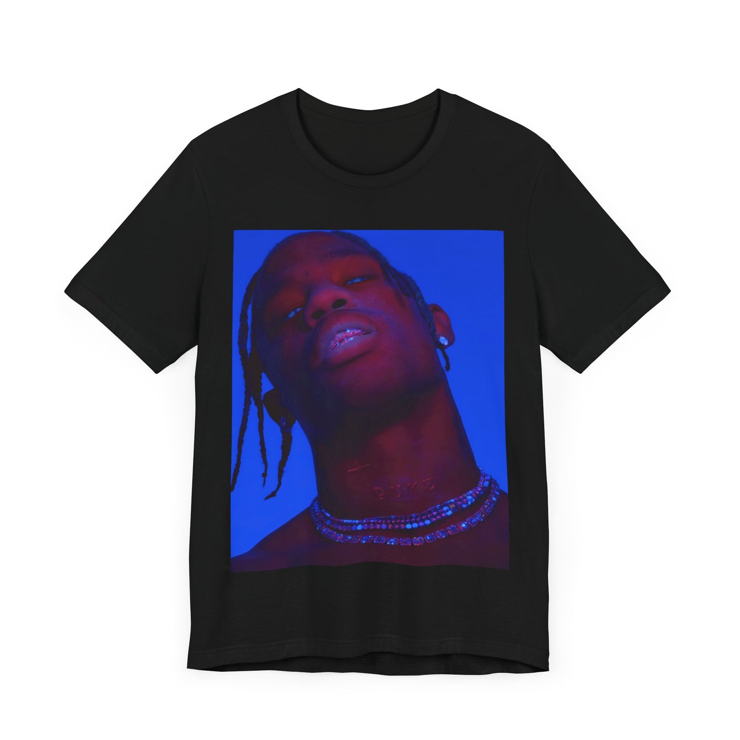 A black graphic t-shirt featuring a bold graphic of Travis Scott as a rap superstar.