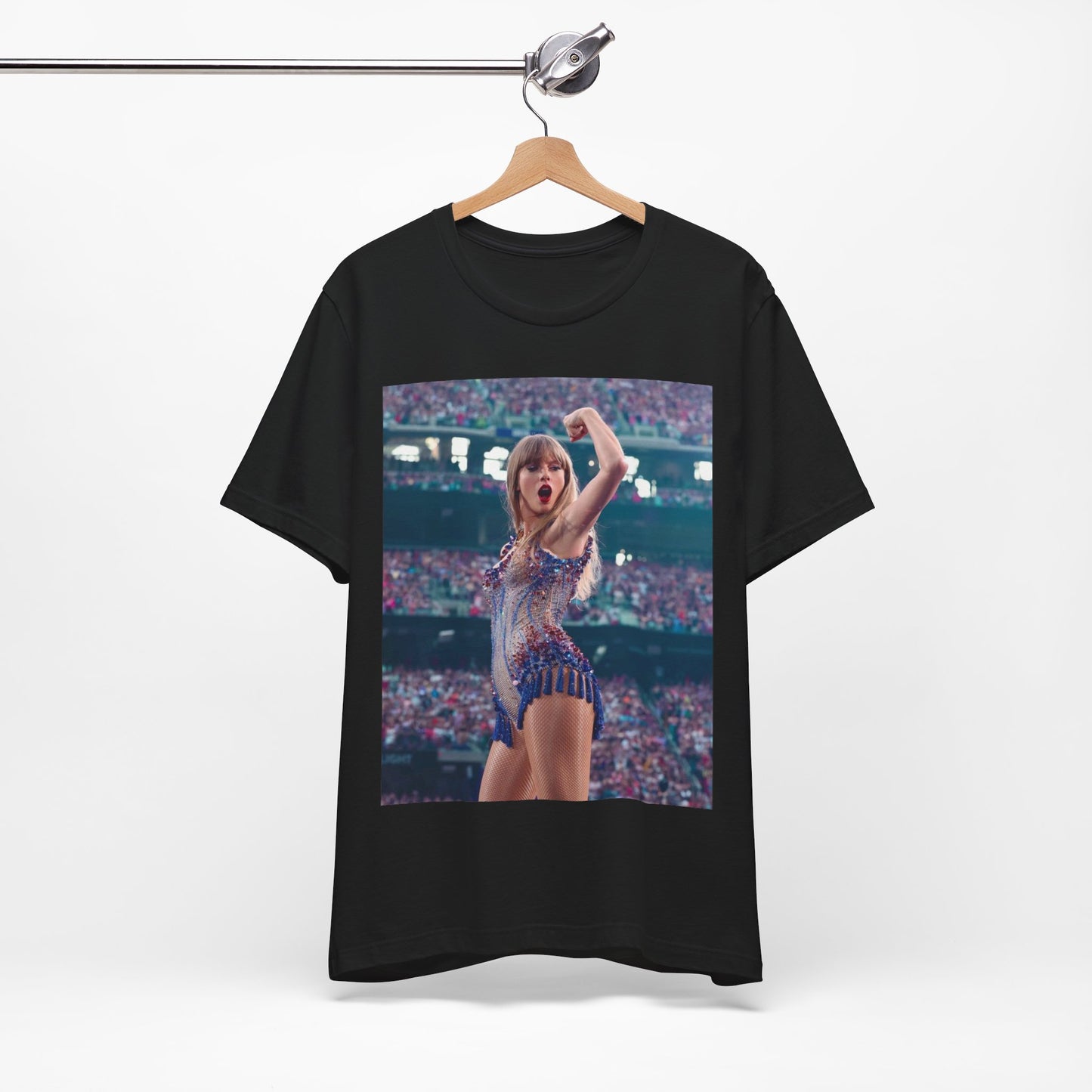 A black graphic t-shirt featuring a graphic or photo of Taylor Swift performing live on stage.