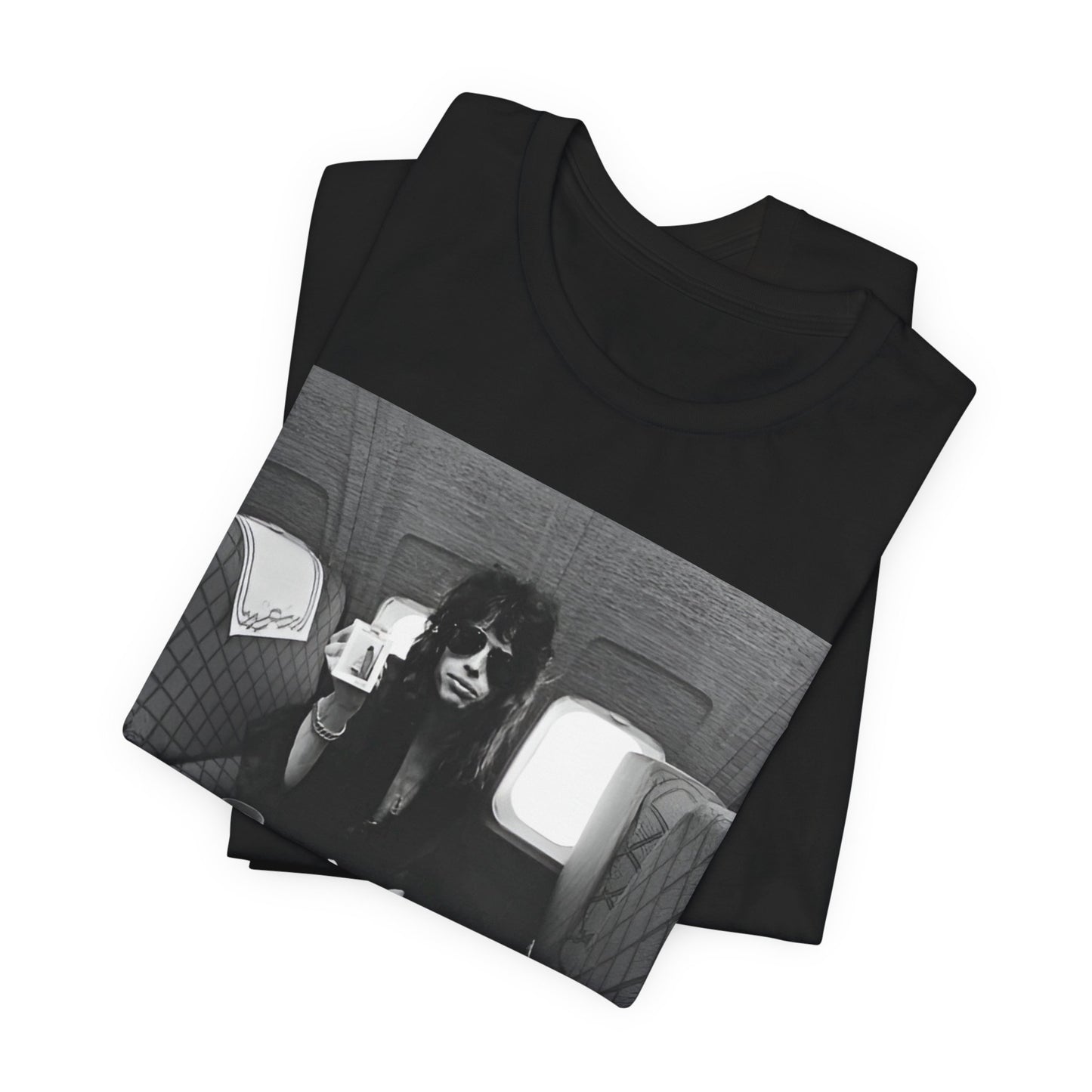 A black graphic t-shirt featuring a vintage 70s-style illustration of an airplane with Aerosmith branding, representing their tour plane from that era.