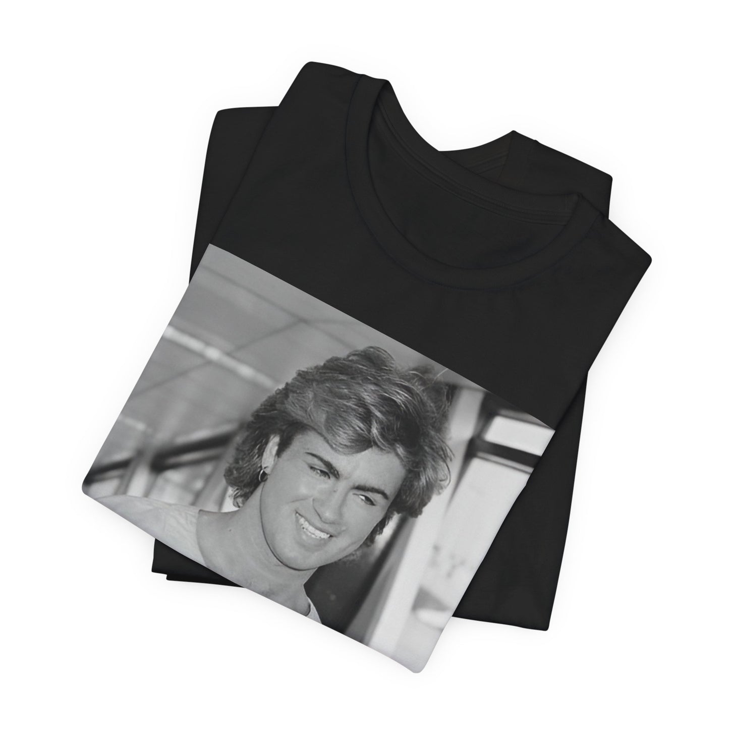 A black graphic t-shirt featuring an 80s black and white vintage photo or graphic of George Michael.