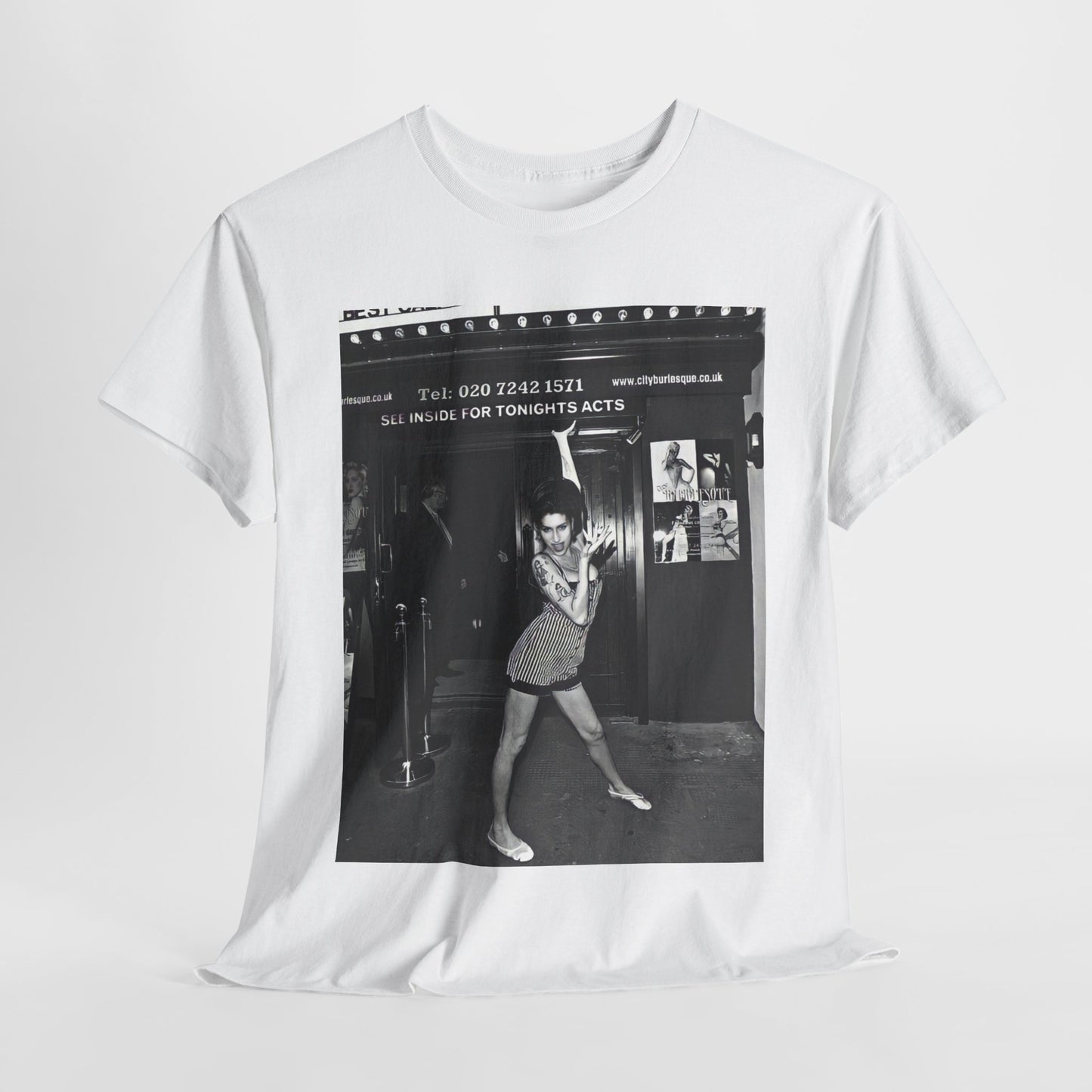 A black graphic t-shirt featuring a black and white graphic of Amy Winehouse in a burlesque club setting, stylized to evoke that ambiance.