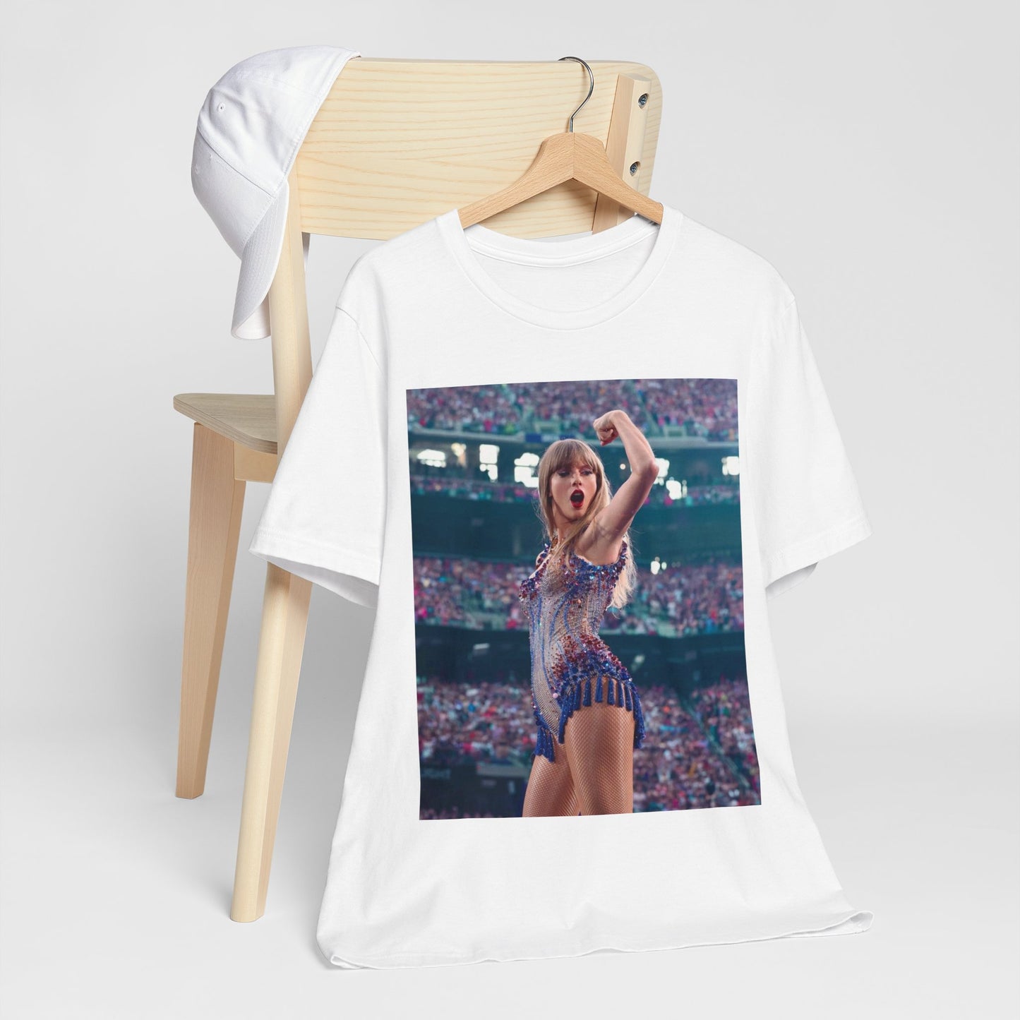 A black graphic t-shirt featuring a graphic or photo of Taylor Swift performing live on stage.