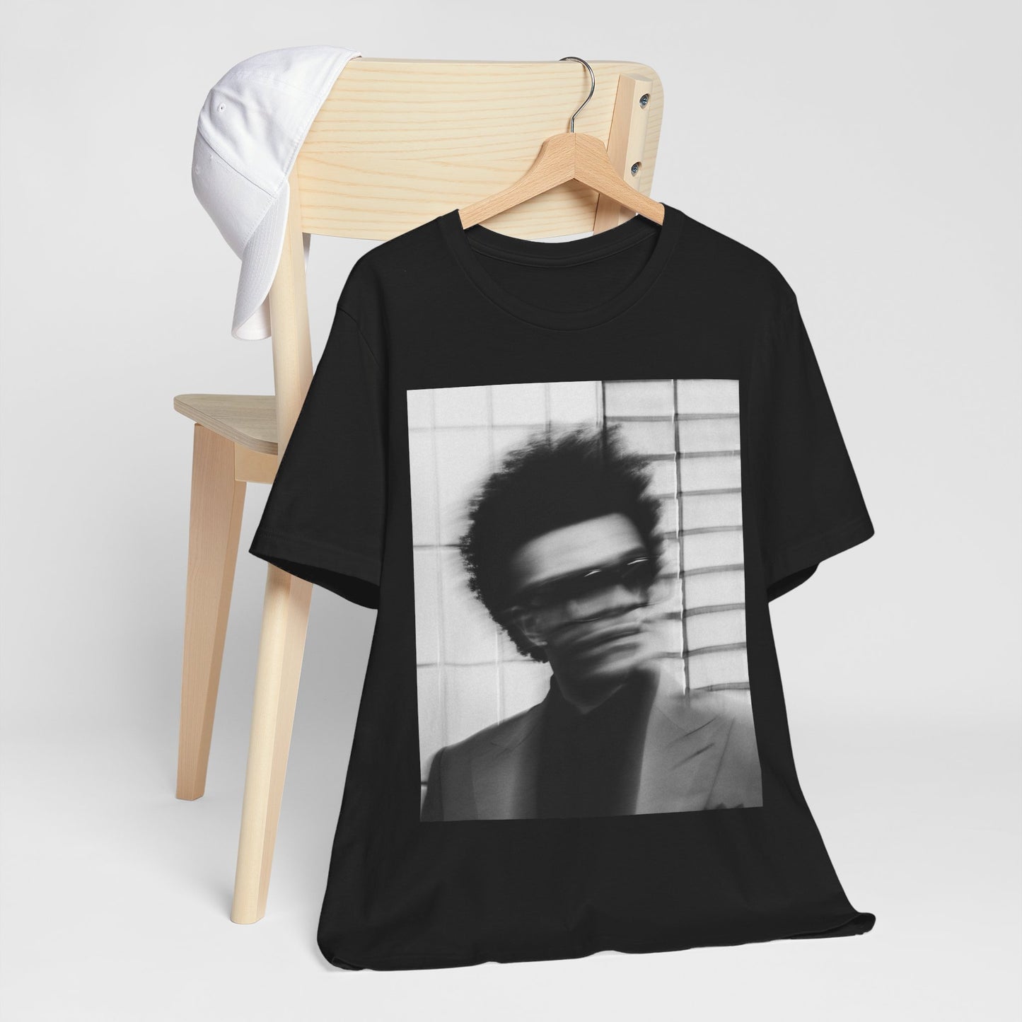 A black graphic t-shirt featuring a blurred graphic of The Weeknd from his 'After Hours' era.