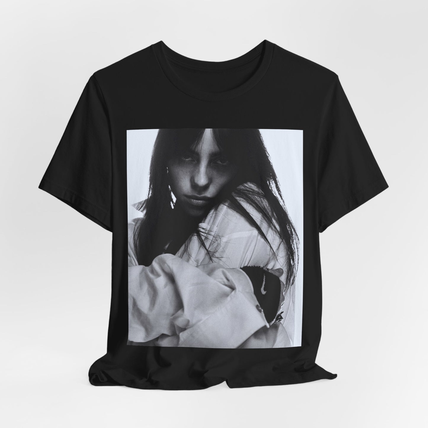 Billie Eilish posing in her signature oversized designer streetwear, printed on a graphic t-shirt.