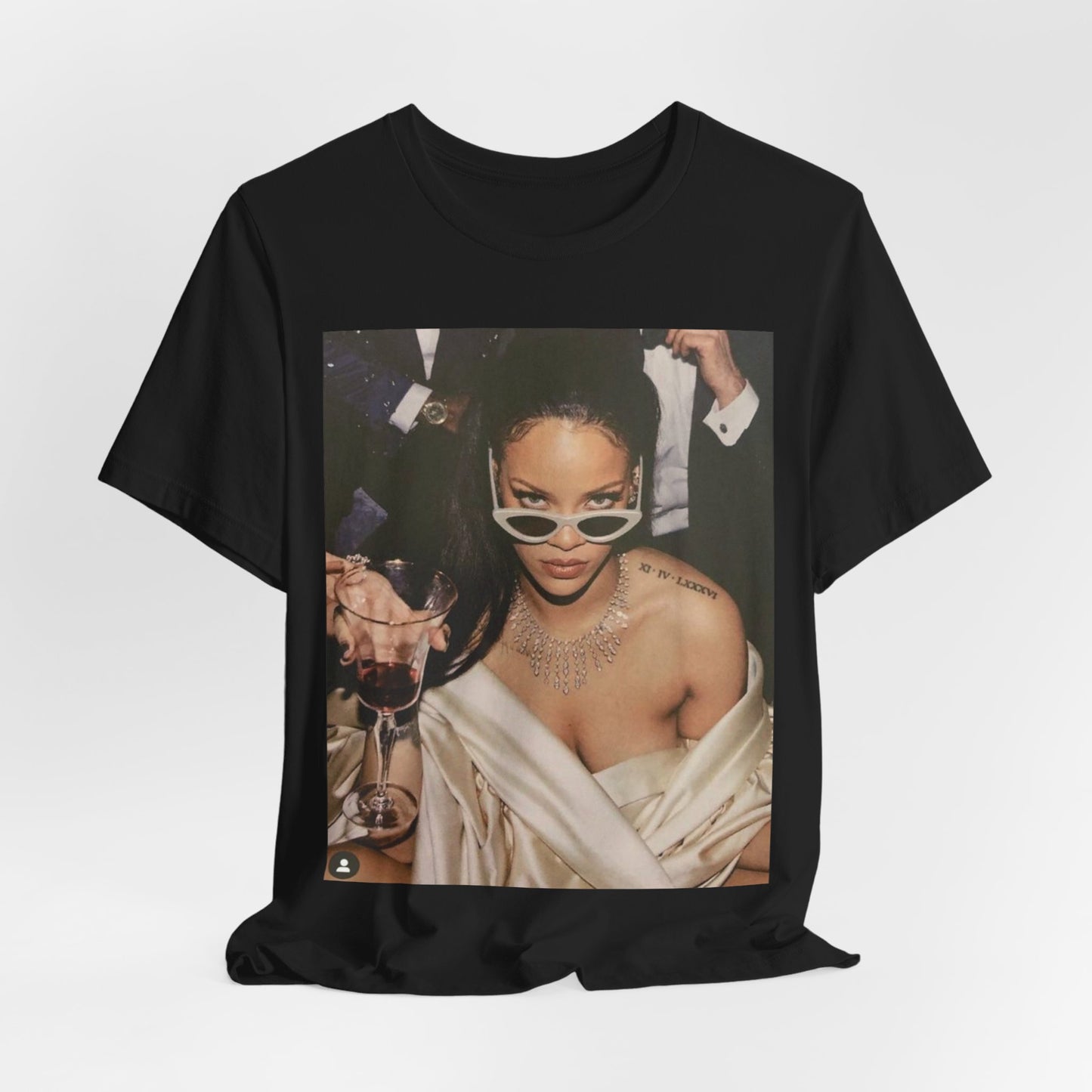 A black graphic t-shirt featuring a graphic of Rihanna as a 'Bad Gal Riri' fashion icon.