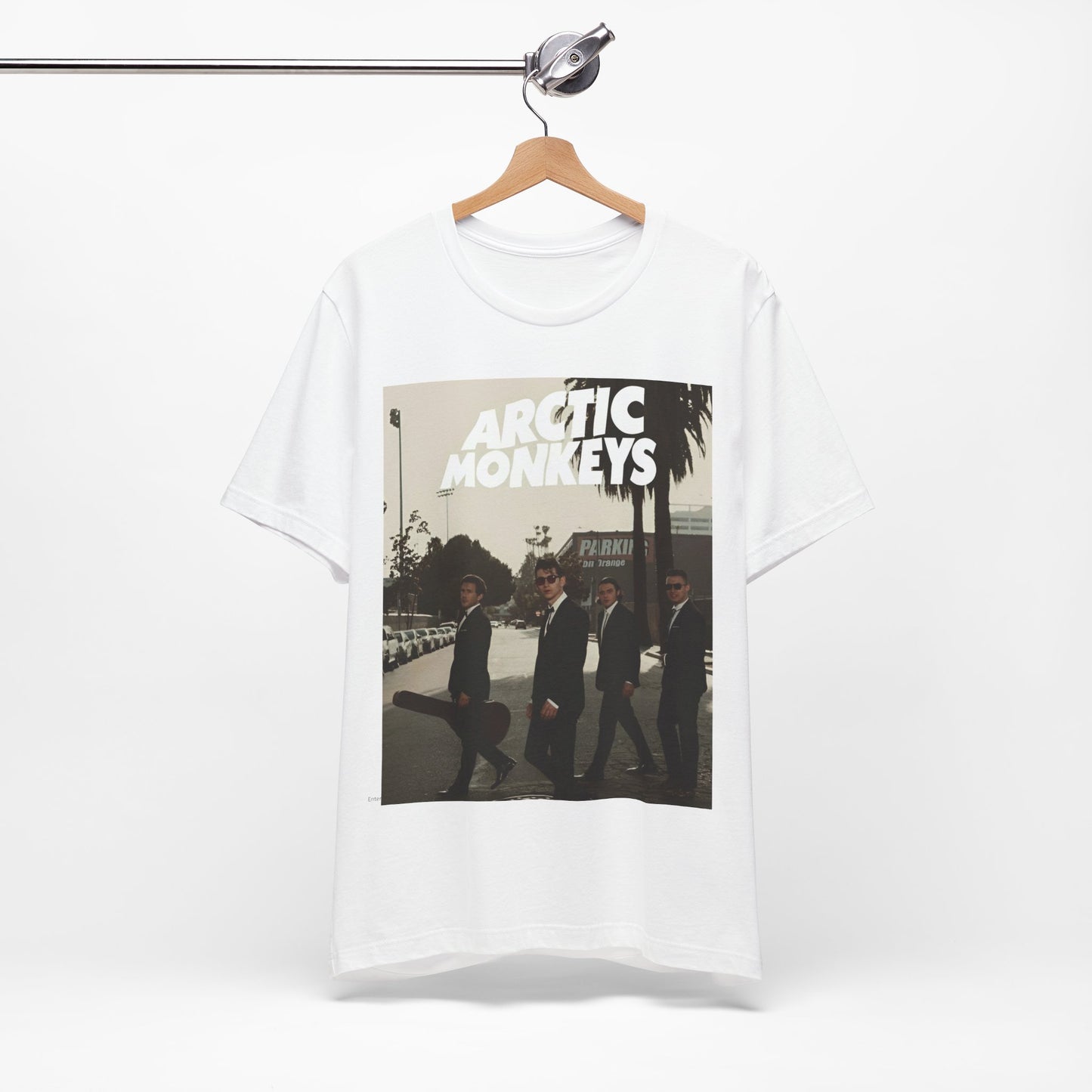 A black graphic t-shirt featuring Arctic Monkeys in a pose or setting similar to the iconic 'Abbey Road' album cover.