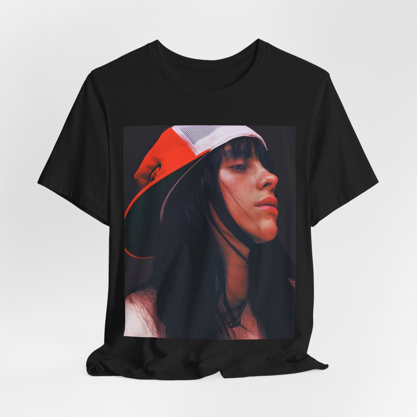 A graphic t-shirt featuring the name 'Billie Eilish' in a raw, urban street-style font.