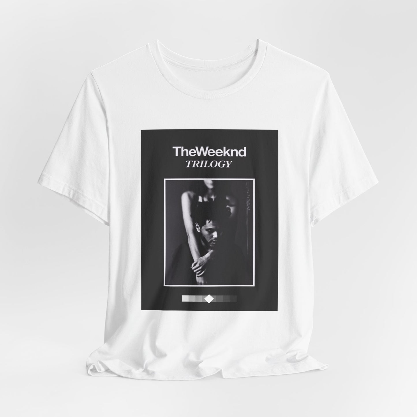A black graphic t-shirt featuring a graphic related to The Weeknd's 'Trilogy' album.