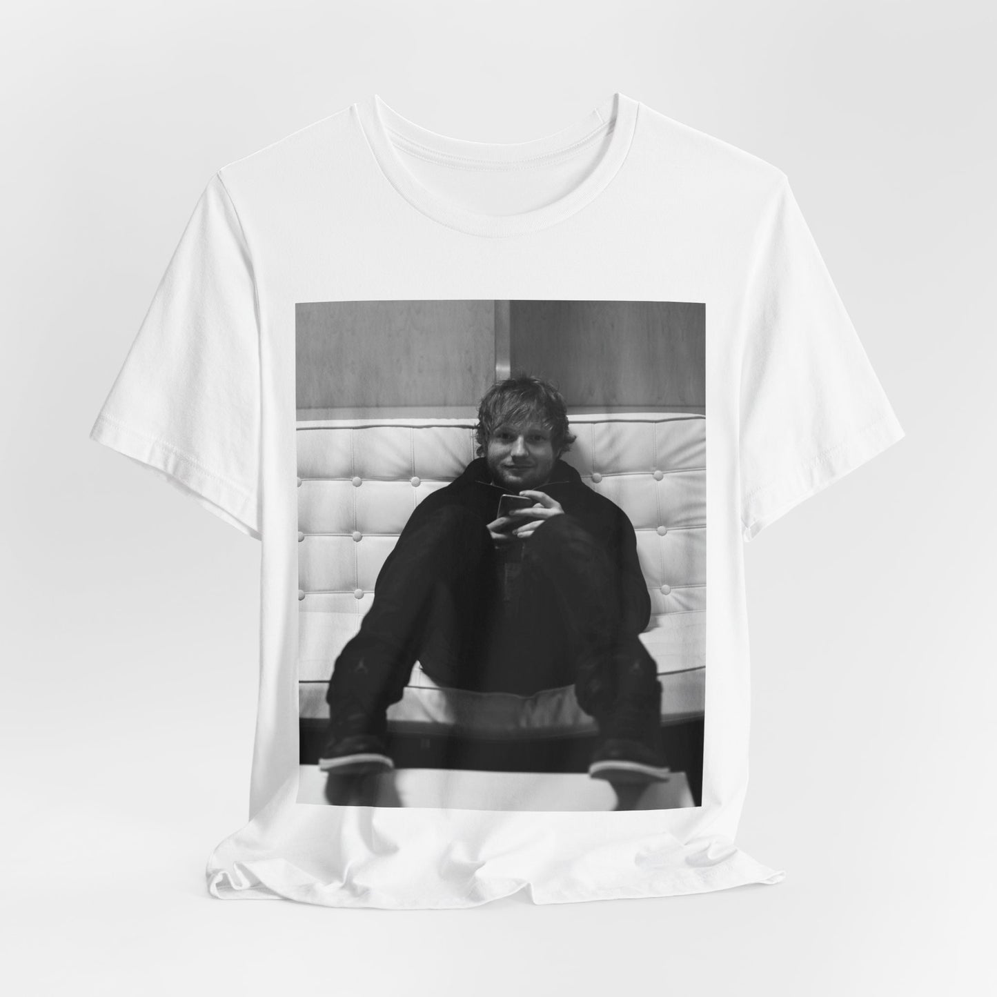 A black graphic t-shirt featuring a bold black and white graphic of Ed Sheeran.