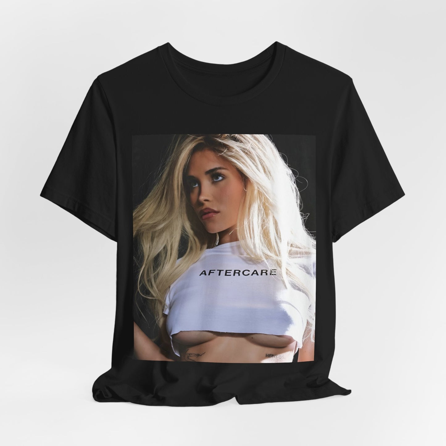 A black graphic t-shirt featuring a graphic related to Nessa Barrett's 'Aftercare' themes.