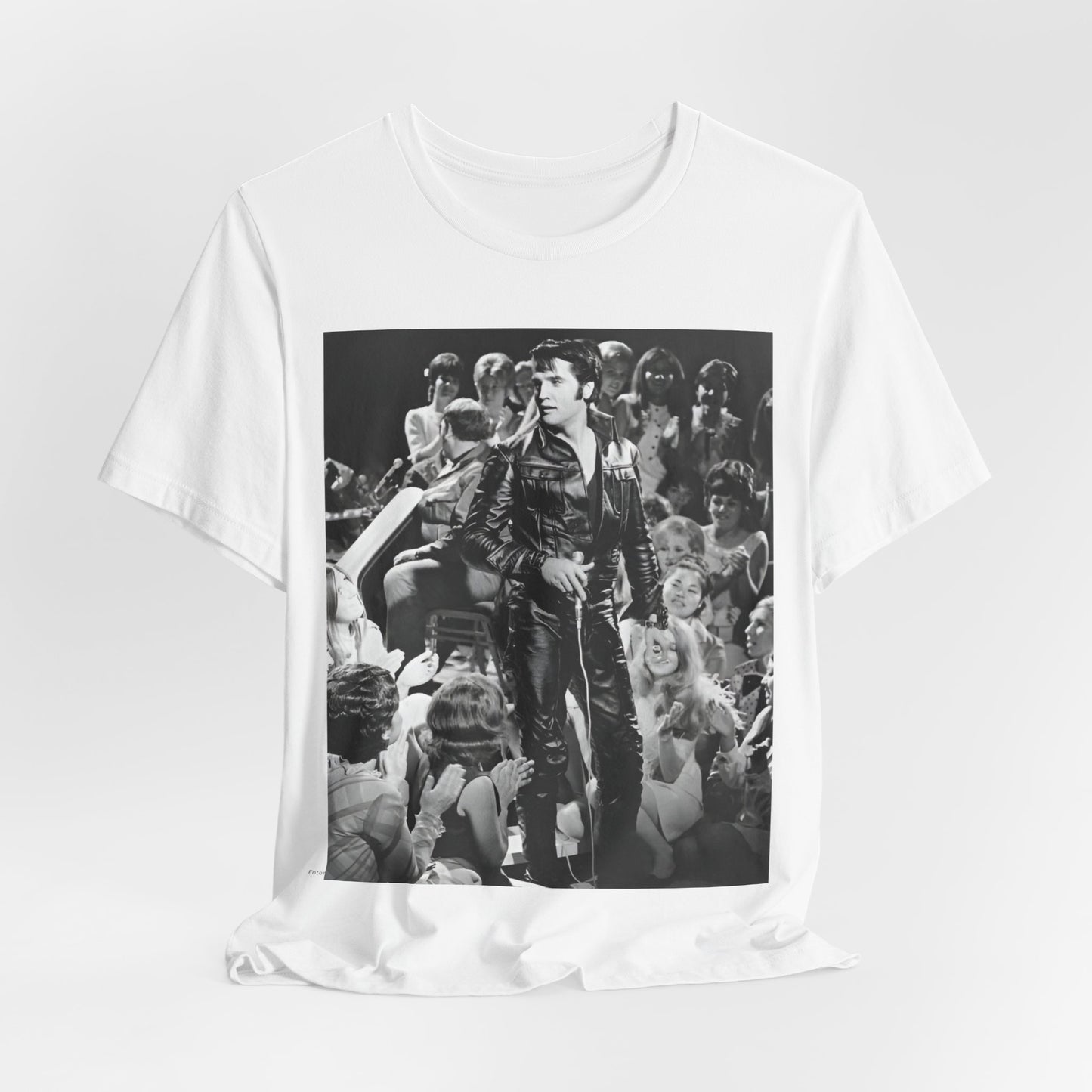 A black graphic t-shirt featuring a vintage black and white photo or graphic of Elvis Presley performing live on stage.