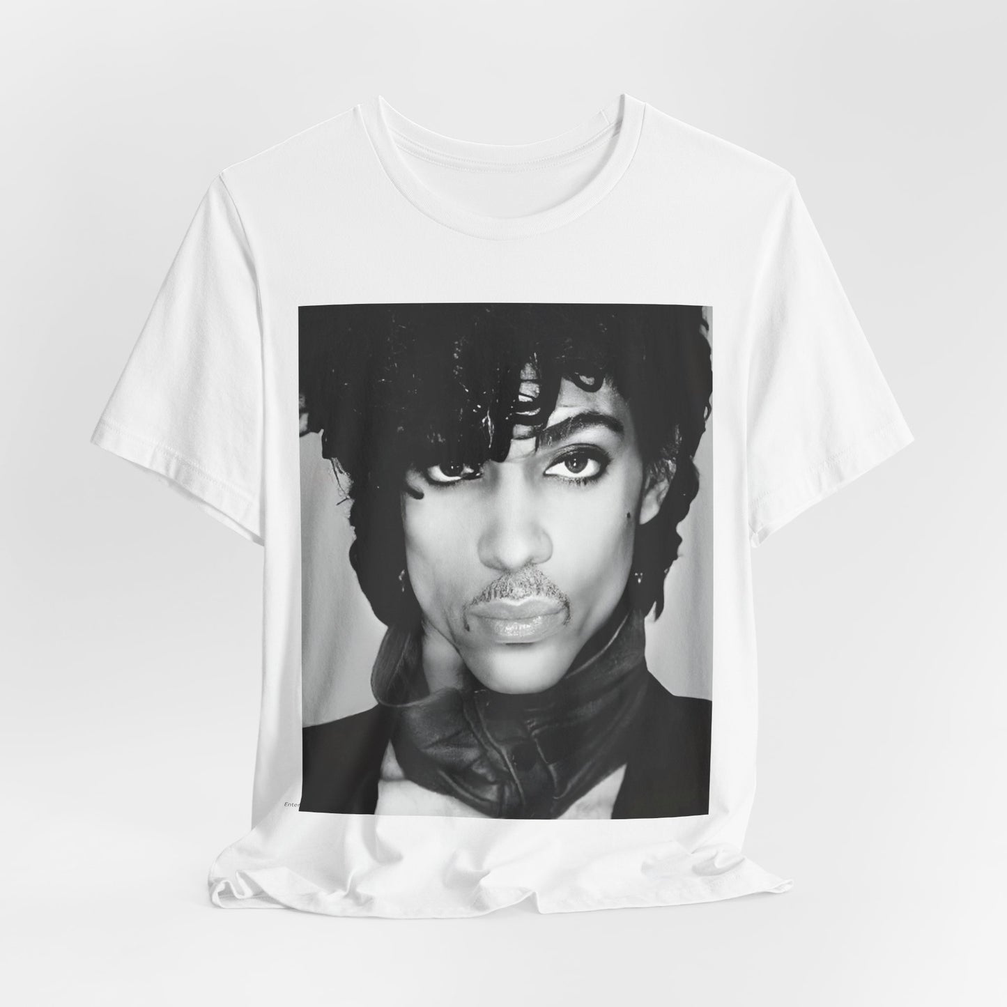 A black graphic t-shirt featuring a black and white photo portrait of Prince.