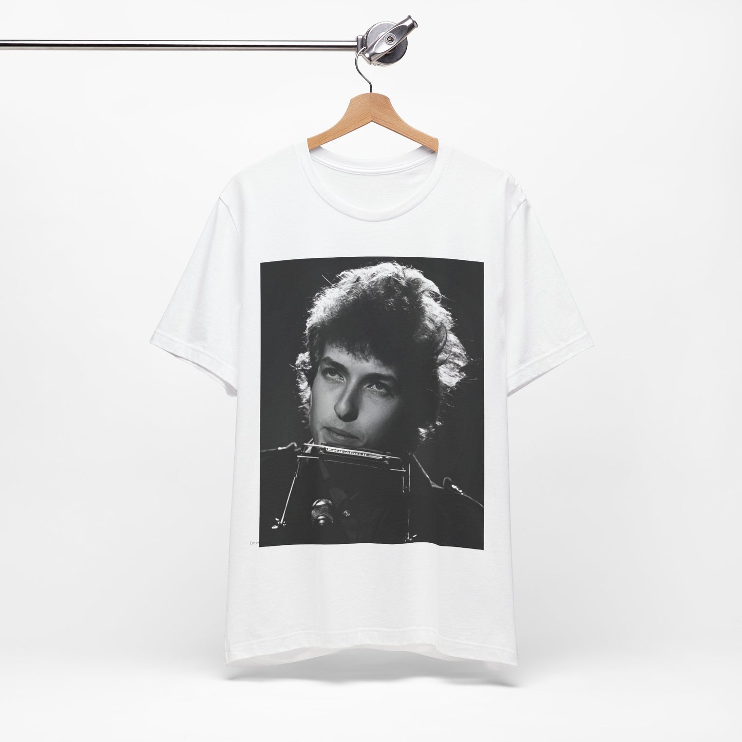 A black graphic t-shirt featuring a graphic of Bob Dylan from the 60s playing his harmonica.