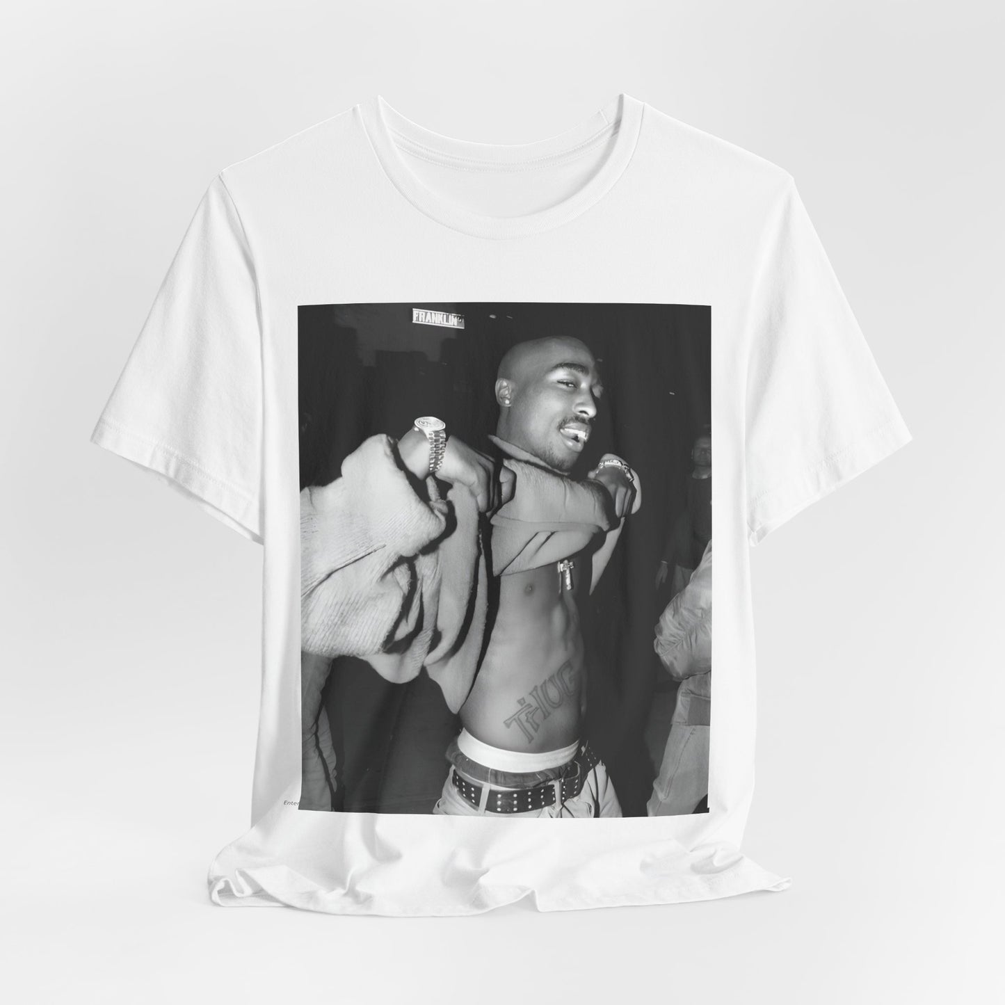 A black graphic t-shirt featuring a vintage hip hop icon graphic of Tupac.