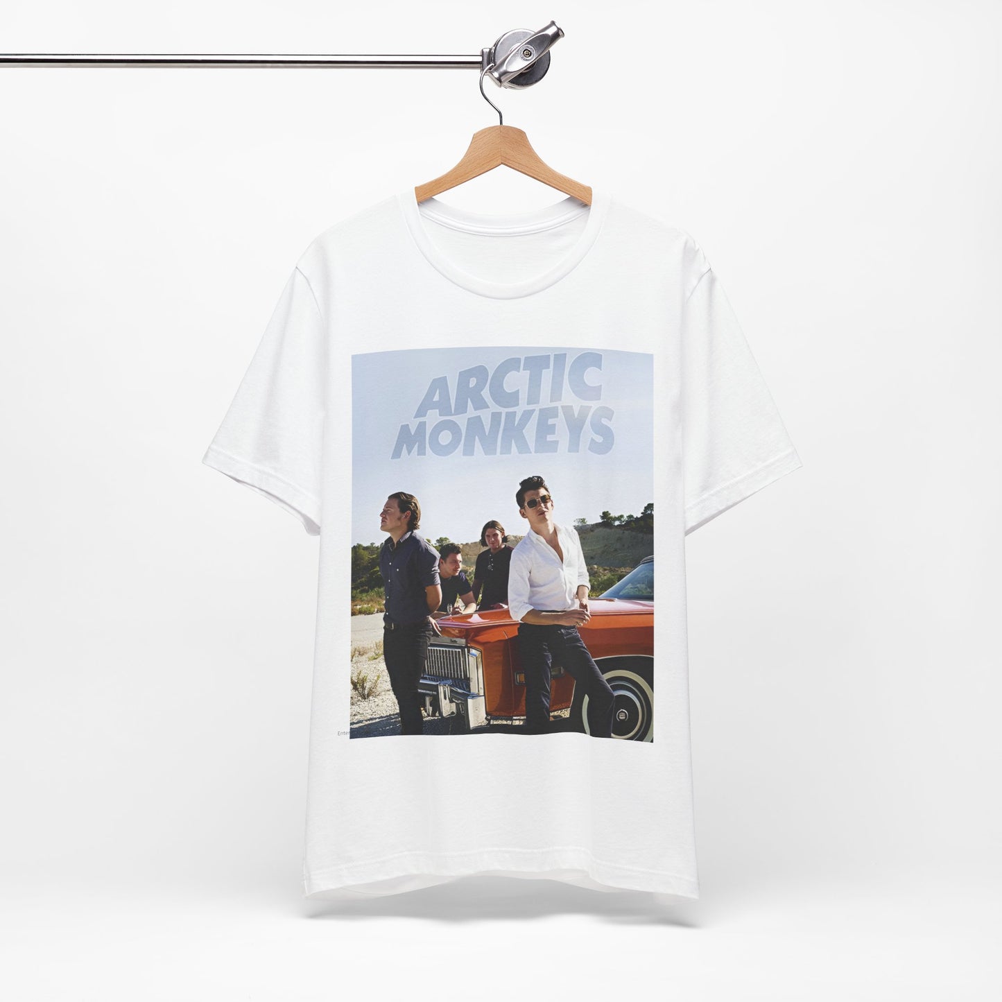 A black graphic t-shirt featuring a design related to Arctic Monkeys' 'AM' album era, possibly with the album art or band imagery.