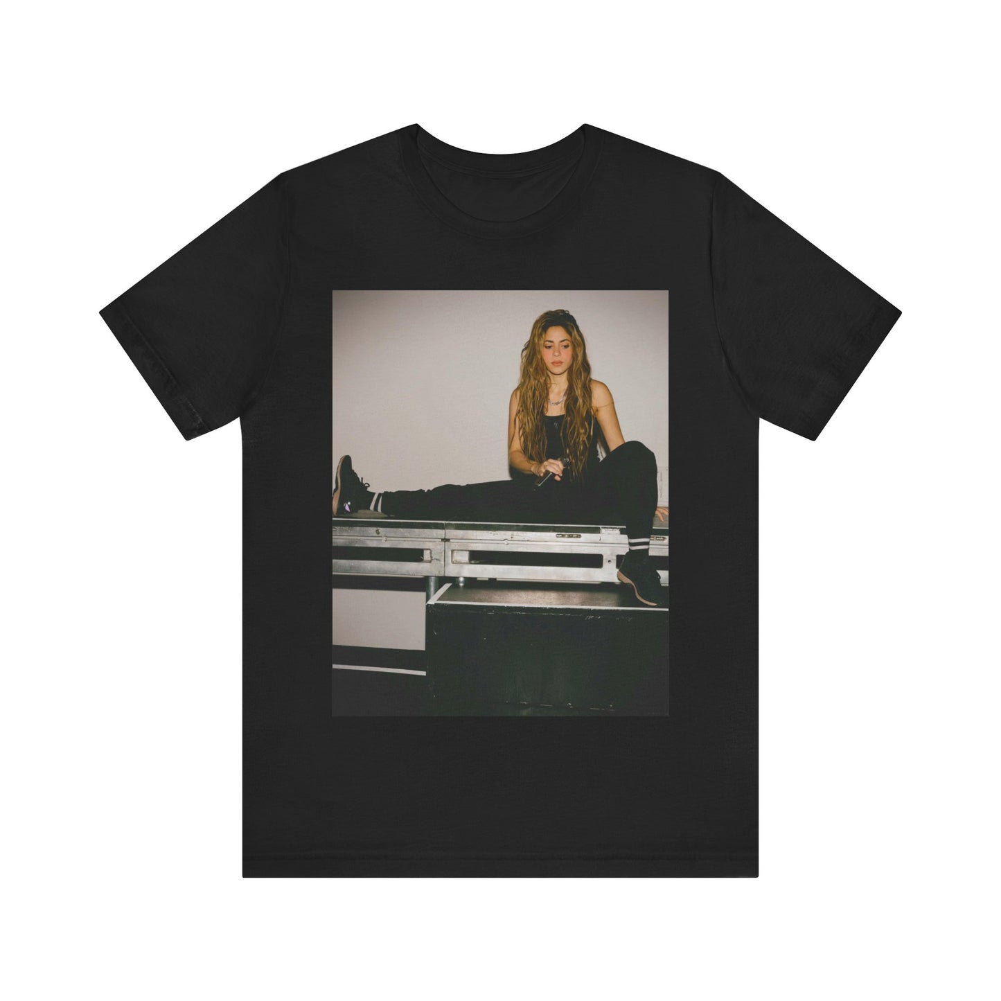A black graphic t-shirt featuring a modern pop essential graphic of Shakira.