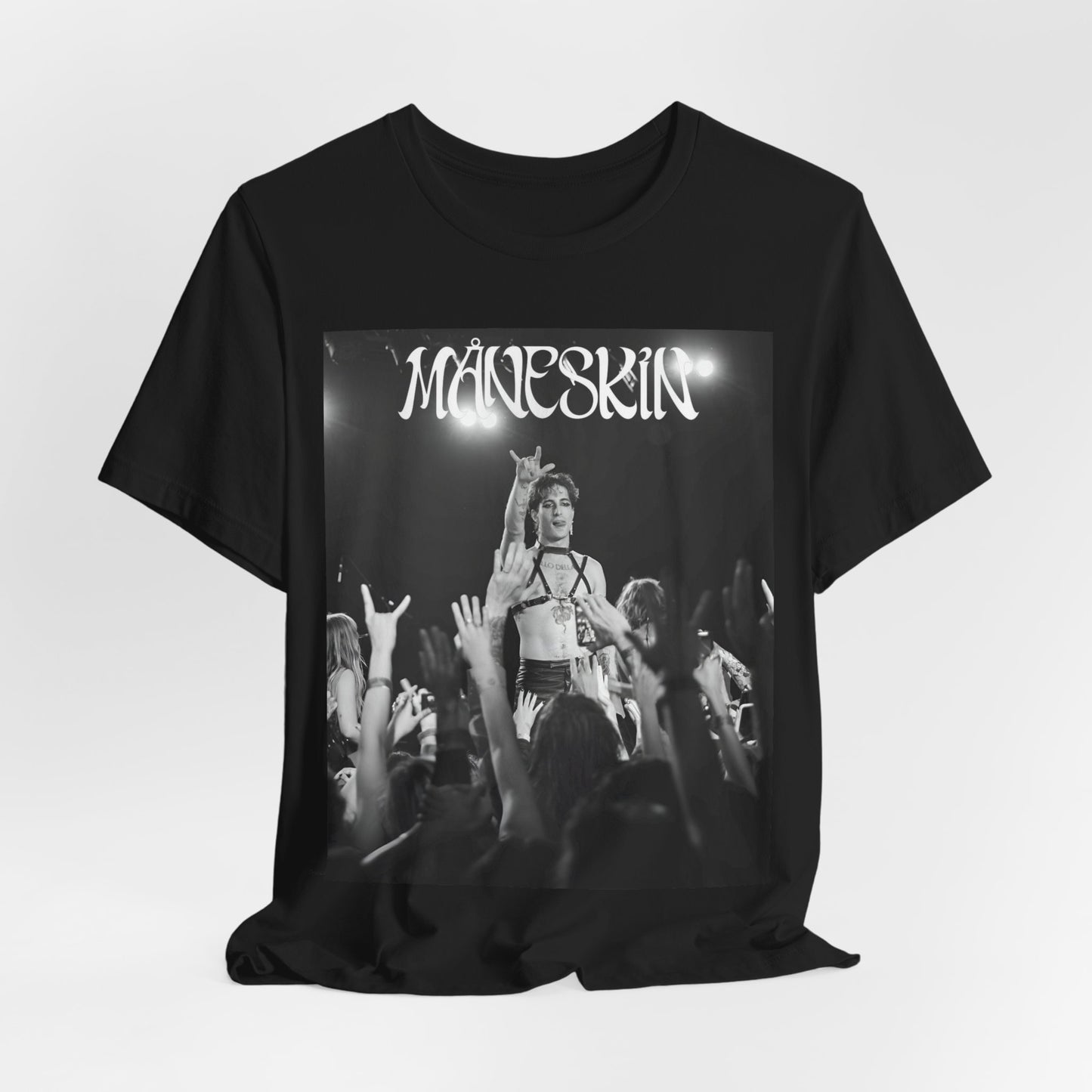 A black graphic t-shirt featuring a graphic or photo of Maneskin performing live.