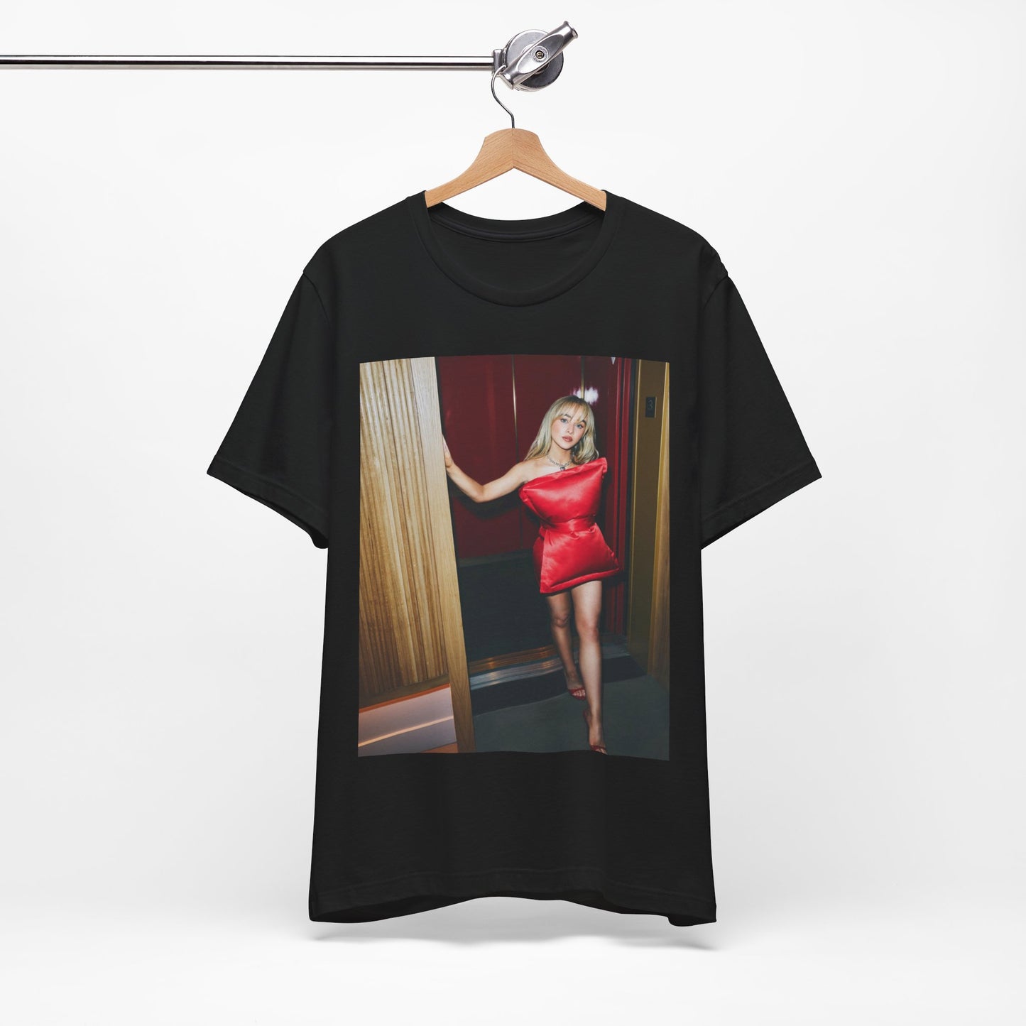 A black graphic t-shirt featuring a graphic of Sabrina Carpenter with 'hot pop vibes'.