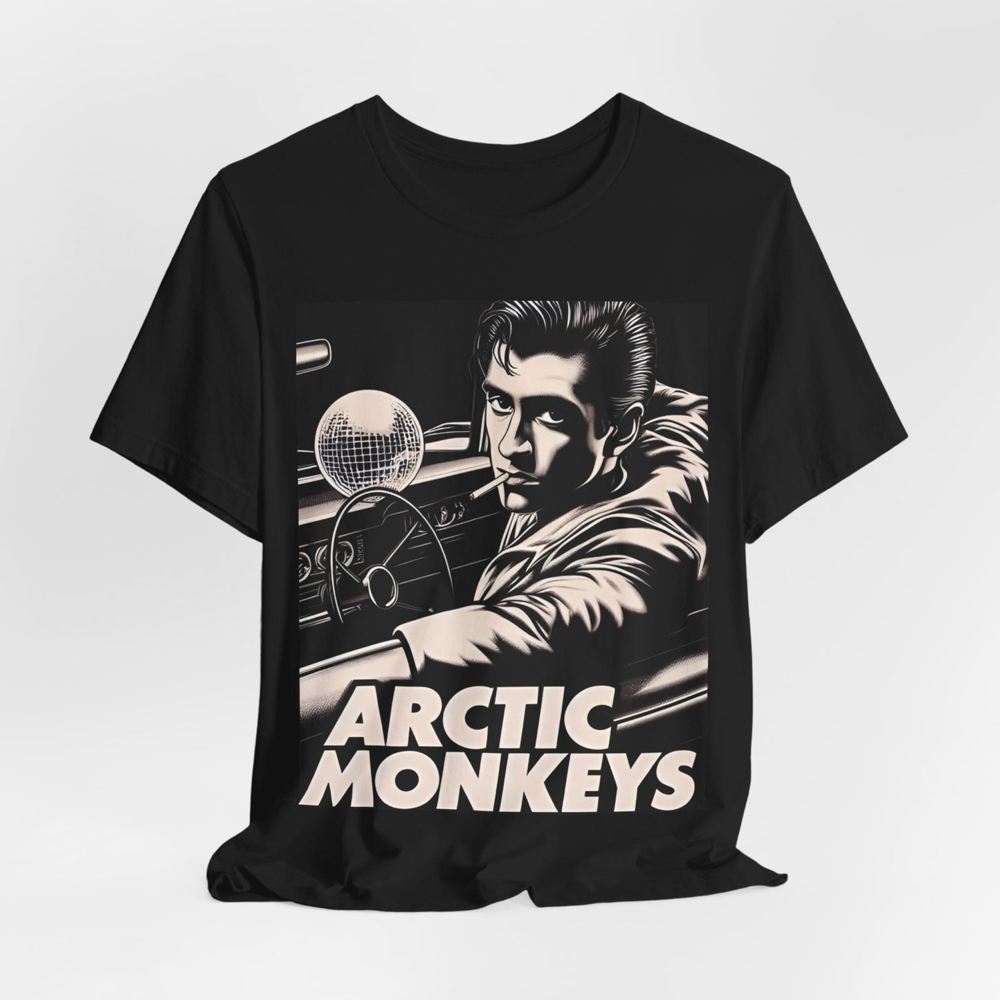 A black graphic t-shirt featuring a graphic of Arctic Monkeys from the 2000s, evoking an indie rock aesthetic.
